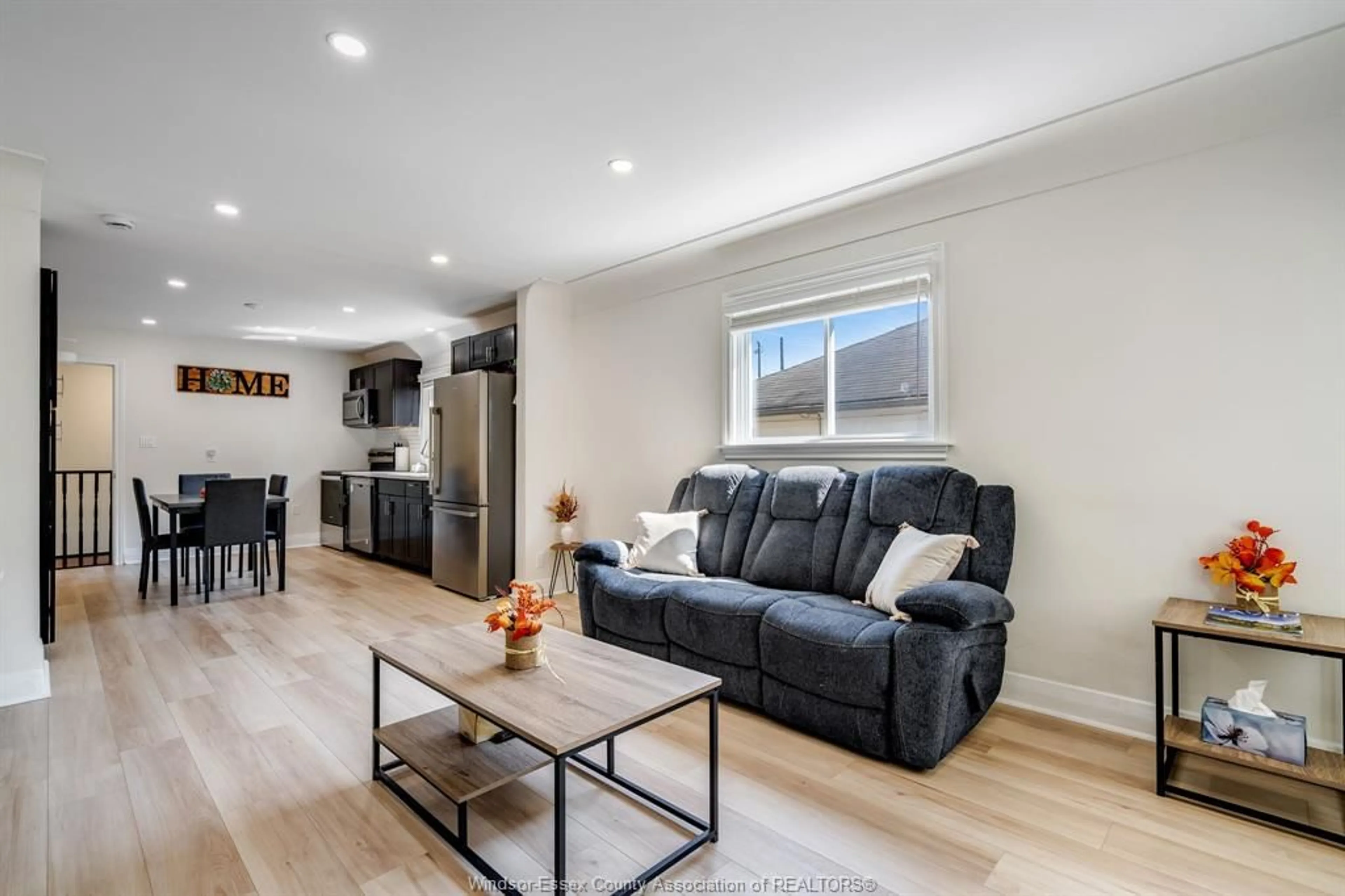 Living room with furniture, wood/laminate floor for 2374 ALEXIS Rd, Windsor Ontario N8W 3Z3