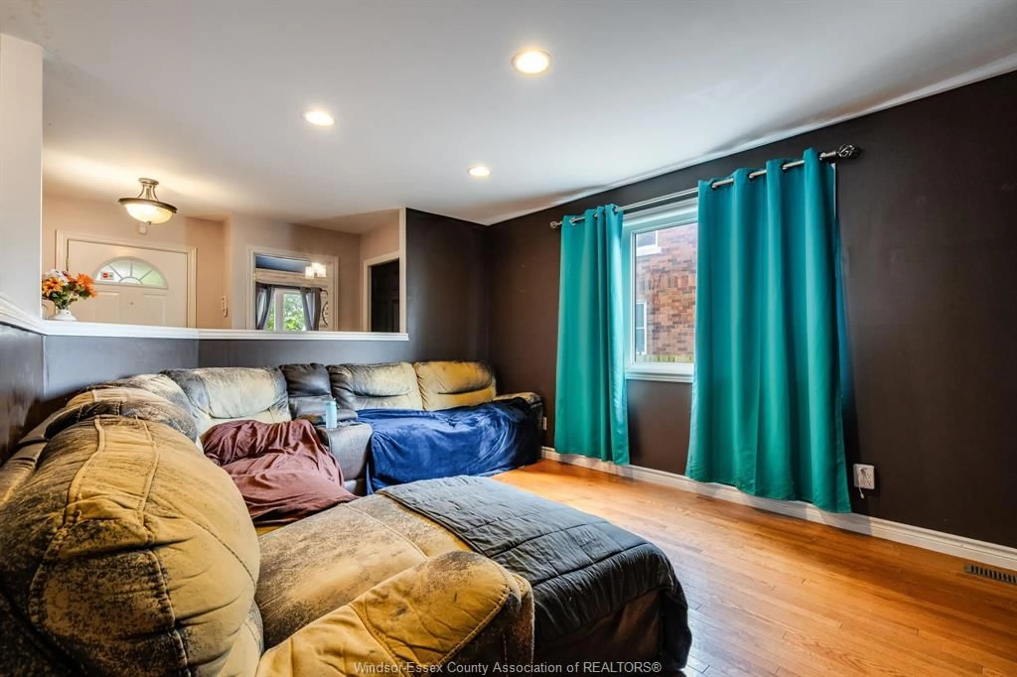 Living room with furniture, wood/laminate floor for 1833 St. Luke, Windsor Ontario N8W 3W8