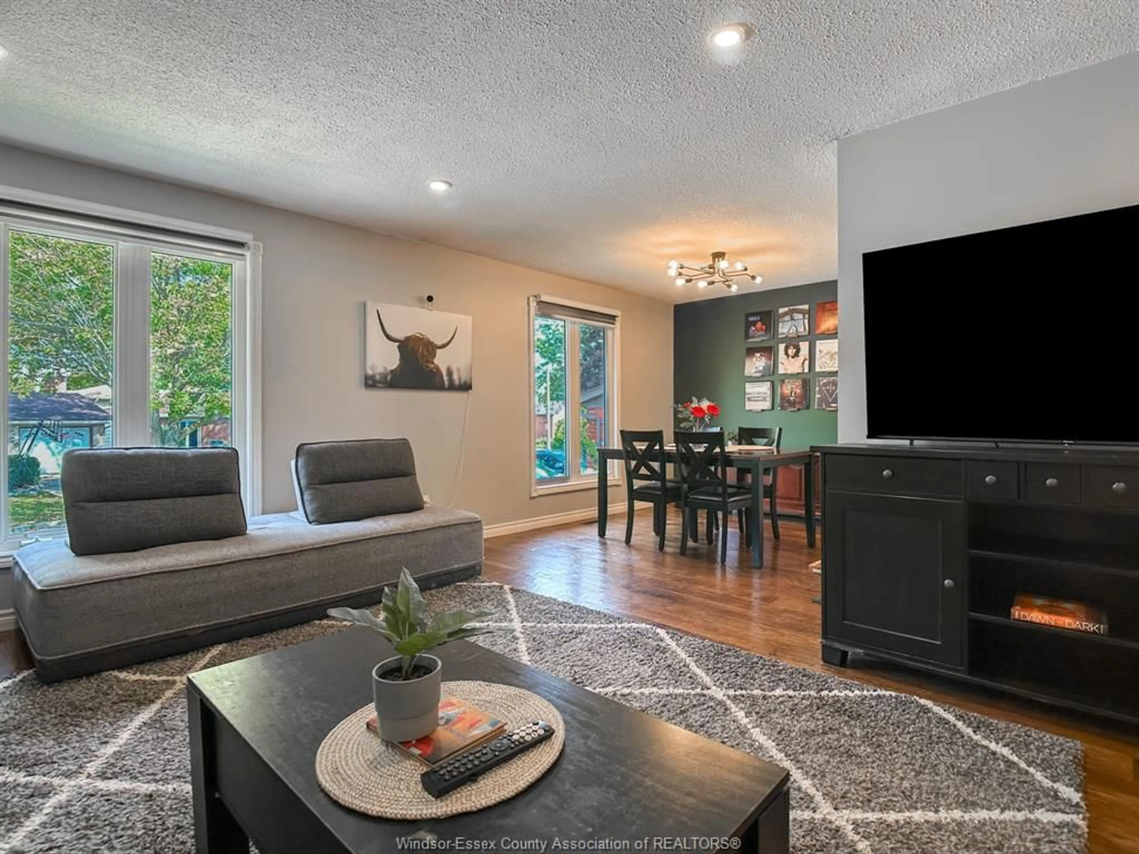 Living room with furniture, wood/laminate floor for 10156 ASPEN Lane, Windsor Ontario N8R 2B8