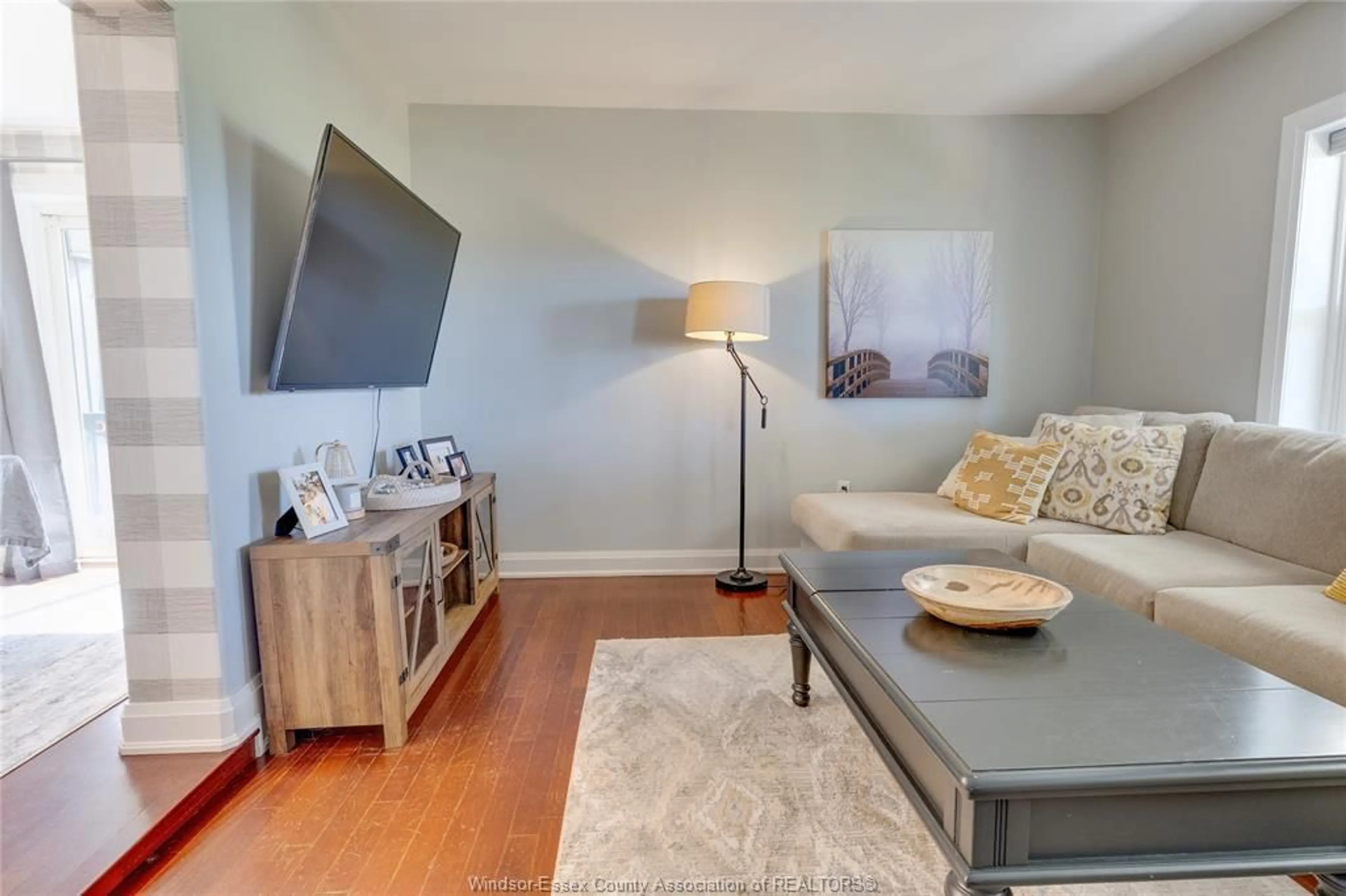 Living room with furniture, wood/laminate floor for 911 Mersea Rd 7, Mersea Ontario N8H 3V8