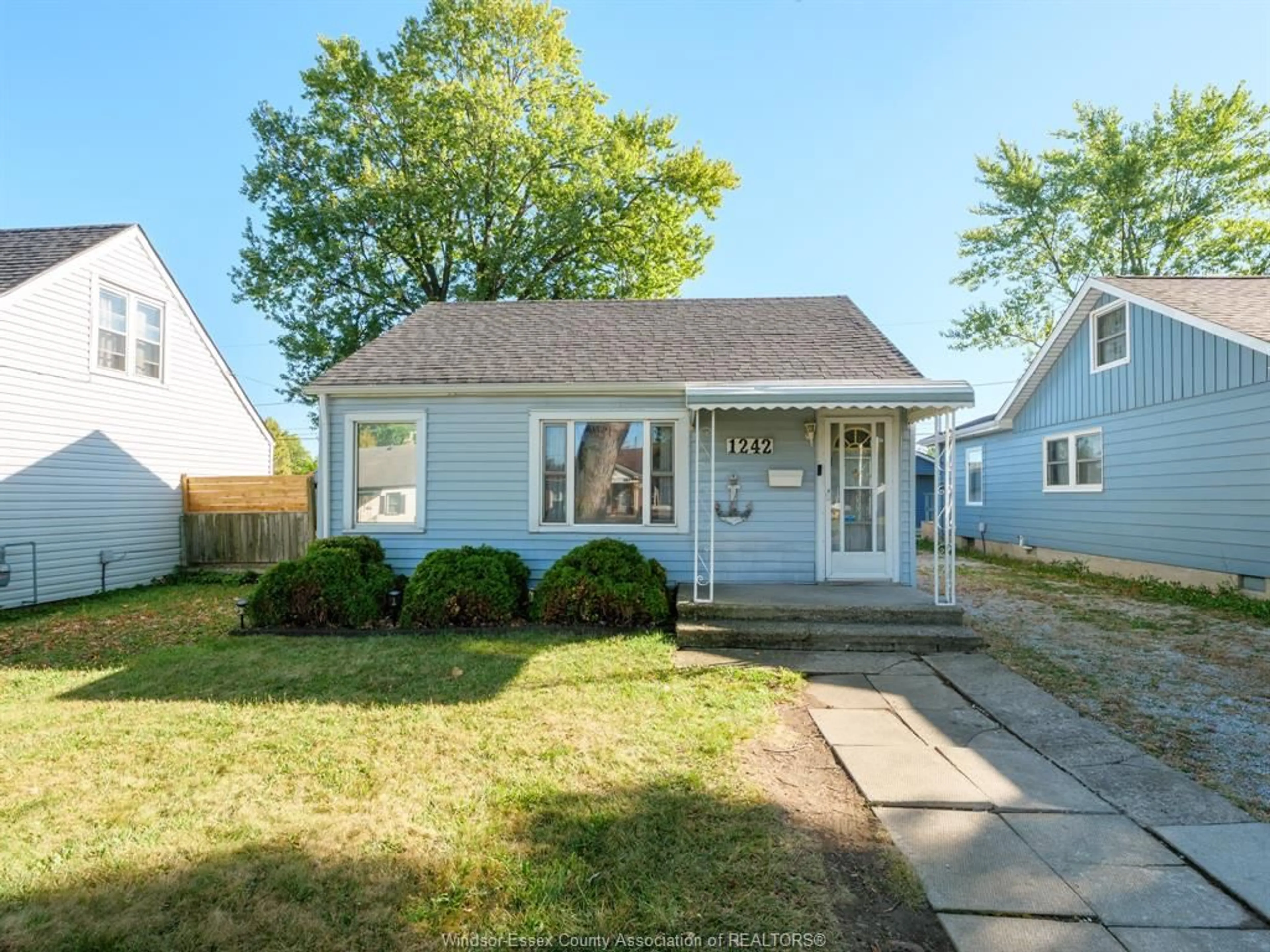 Home with vinyl exterior material, street for 1242 PARTINGTON Ave, Windsor Ontario N9B 2P4