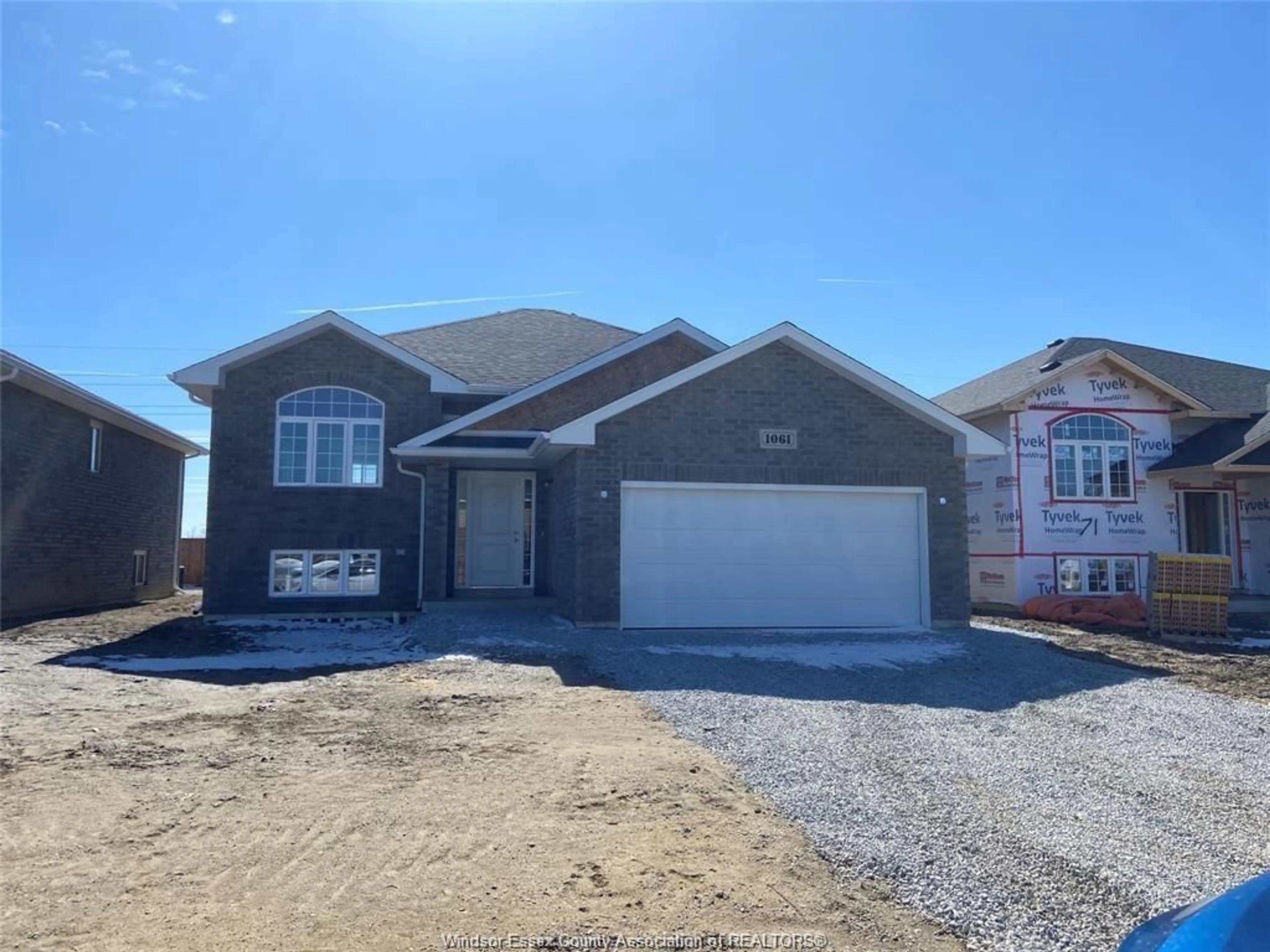 Home with brick exterior material, street for 1061 ASPEN RIDGE Cres, Lakeshore Ontario N0R 1A0