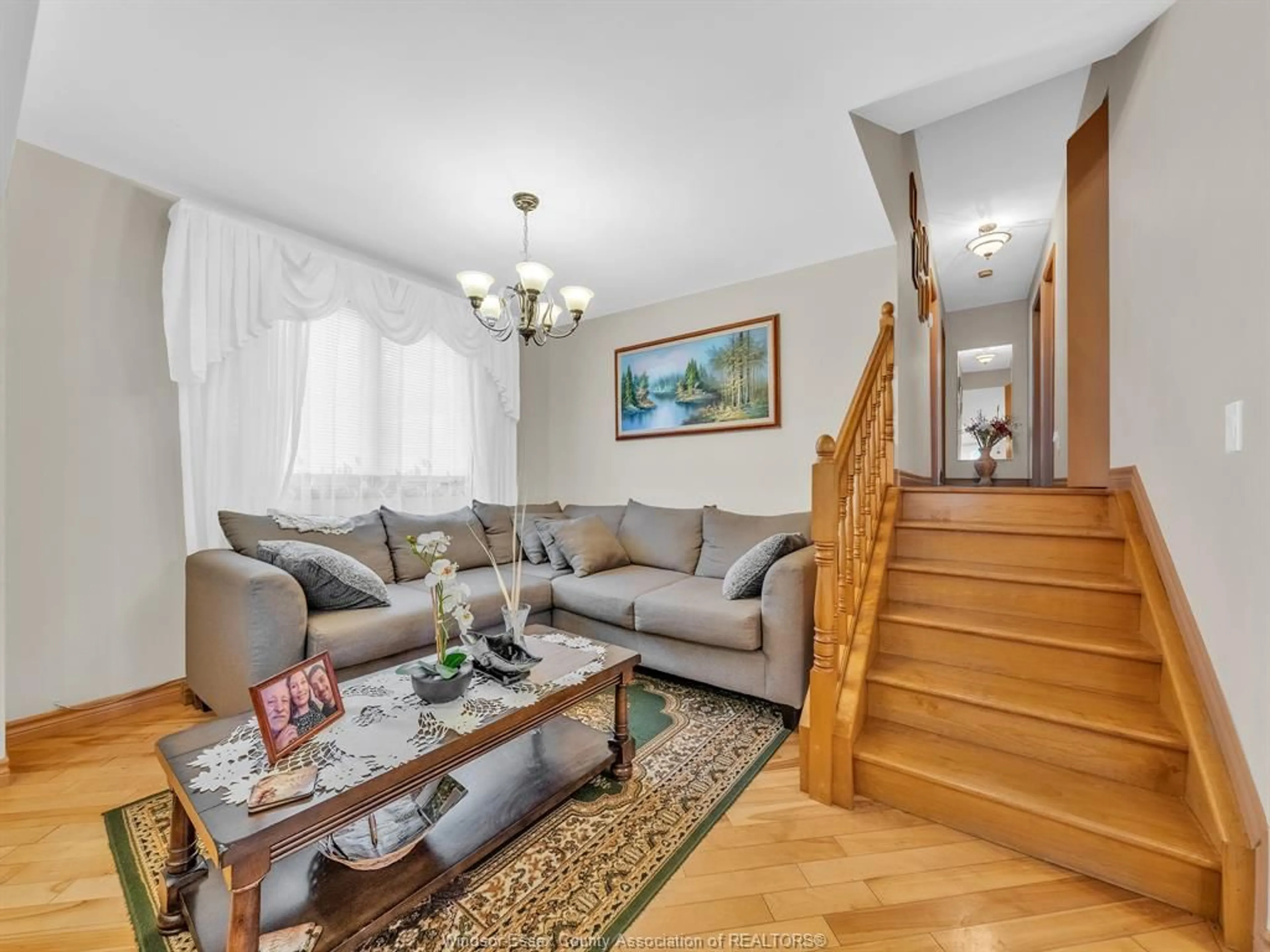 Living room with furniture, wood/laminate floor for 9318 TAMARACK St, Windsor Ontario N8R 1Y8