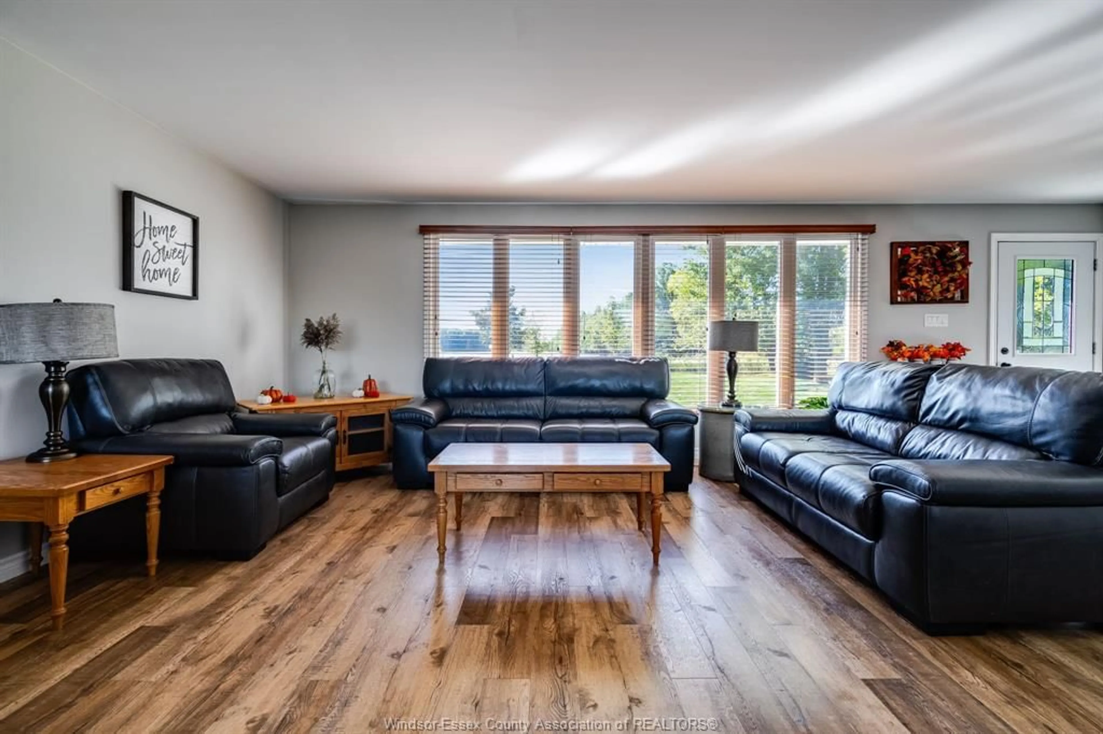 Living room with furniture, wood/laminate floor for 6958 6 Concession Road, Essex Ontario N9Y 2E5