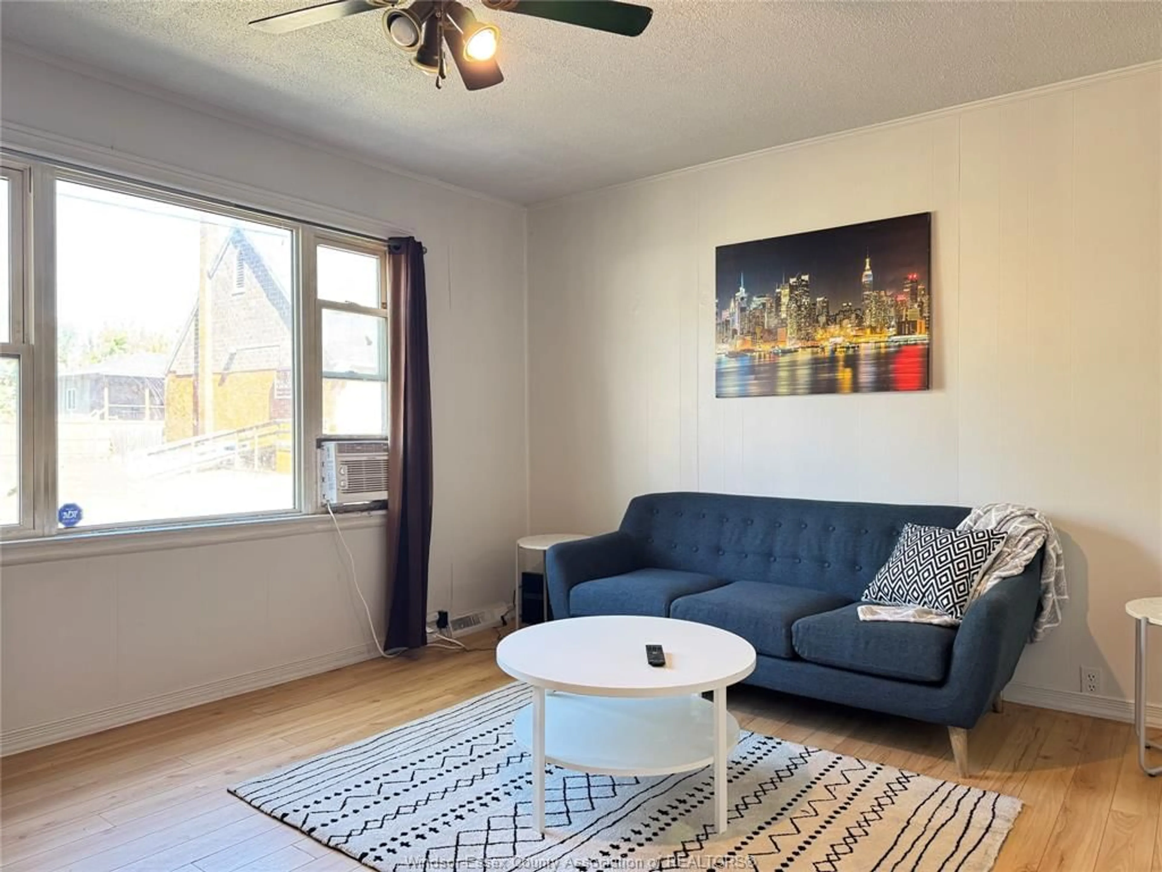 Living room with furniture, wood/laminate floor for 255 ELLIOTT, Windsor Ontario N9A 3R7