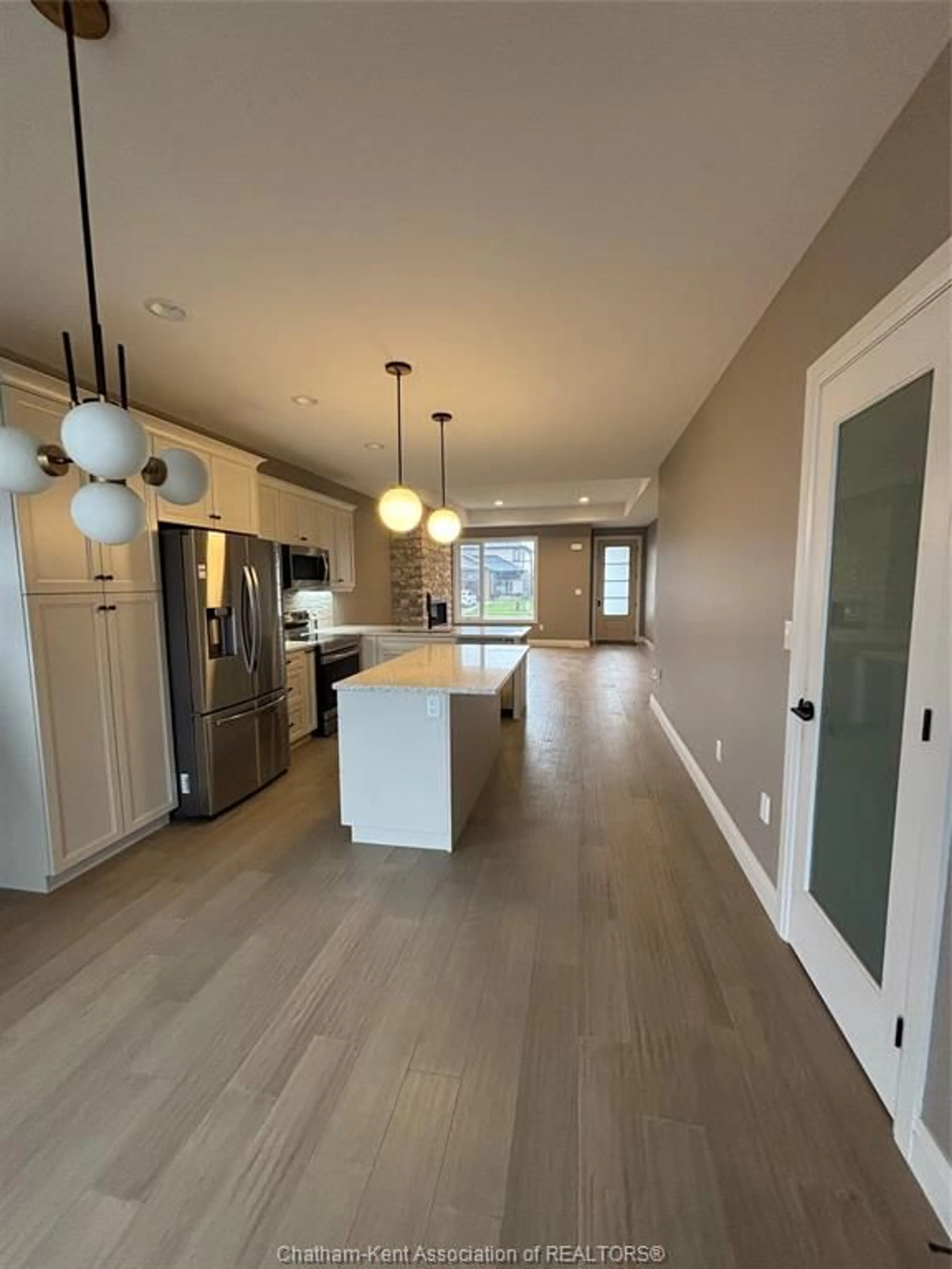 Open concept kitchen, wood/laminate floor for 22 Evening Dr, Chatham Ontario N7L 0B6
