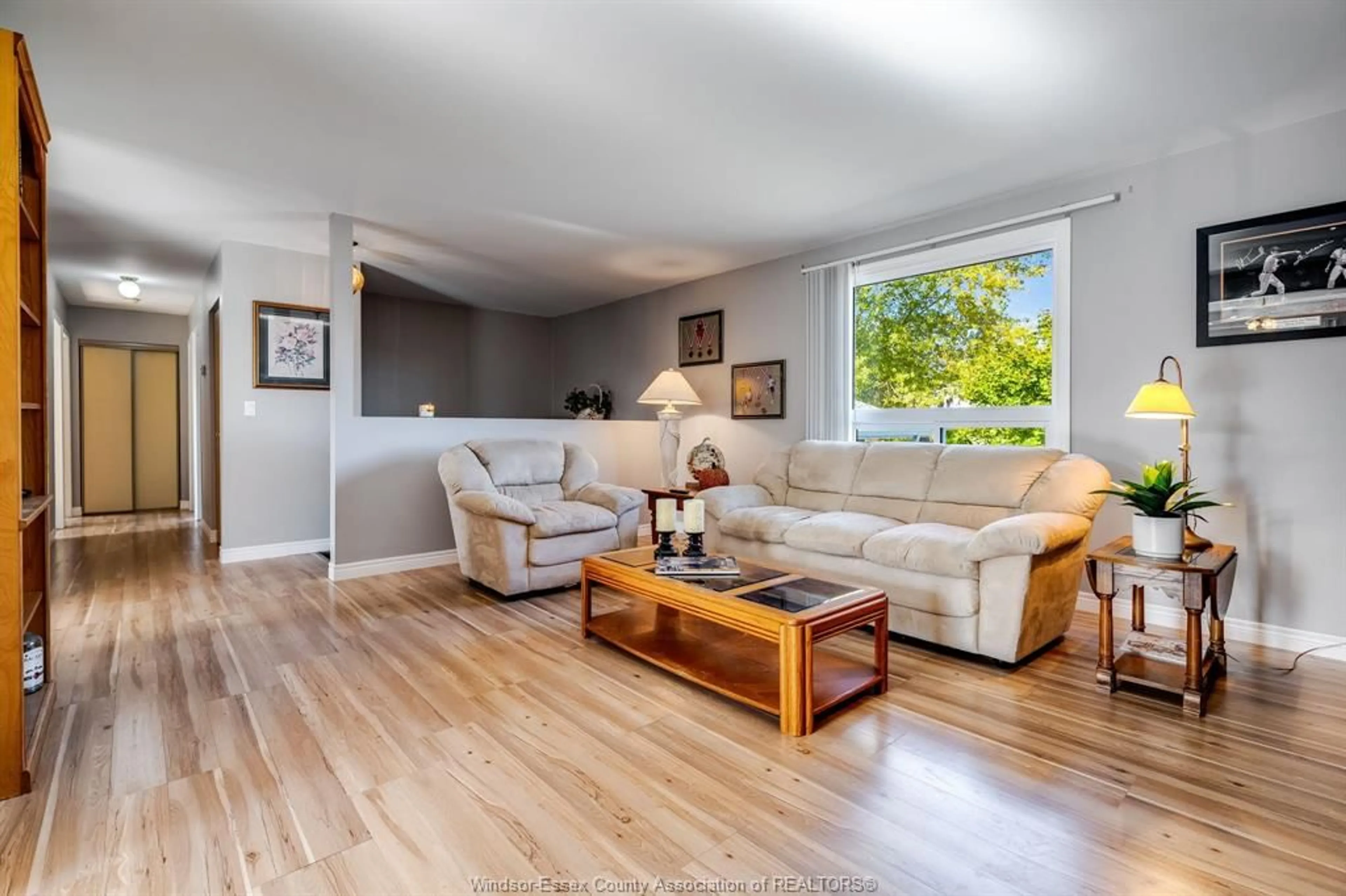 Living room with furniture, wood/laminate floor for 1587 Oakwood, Lakeshore Ontario N8L 1C8