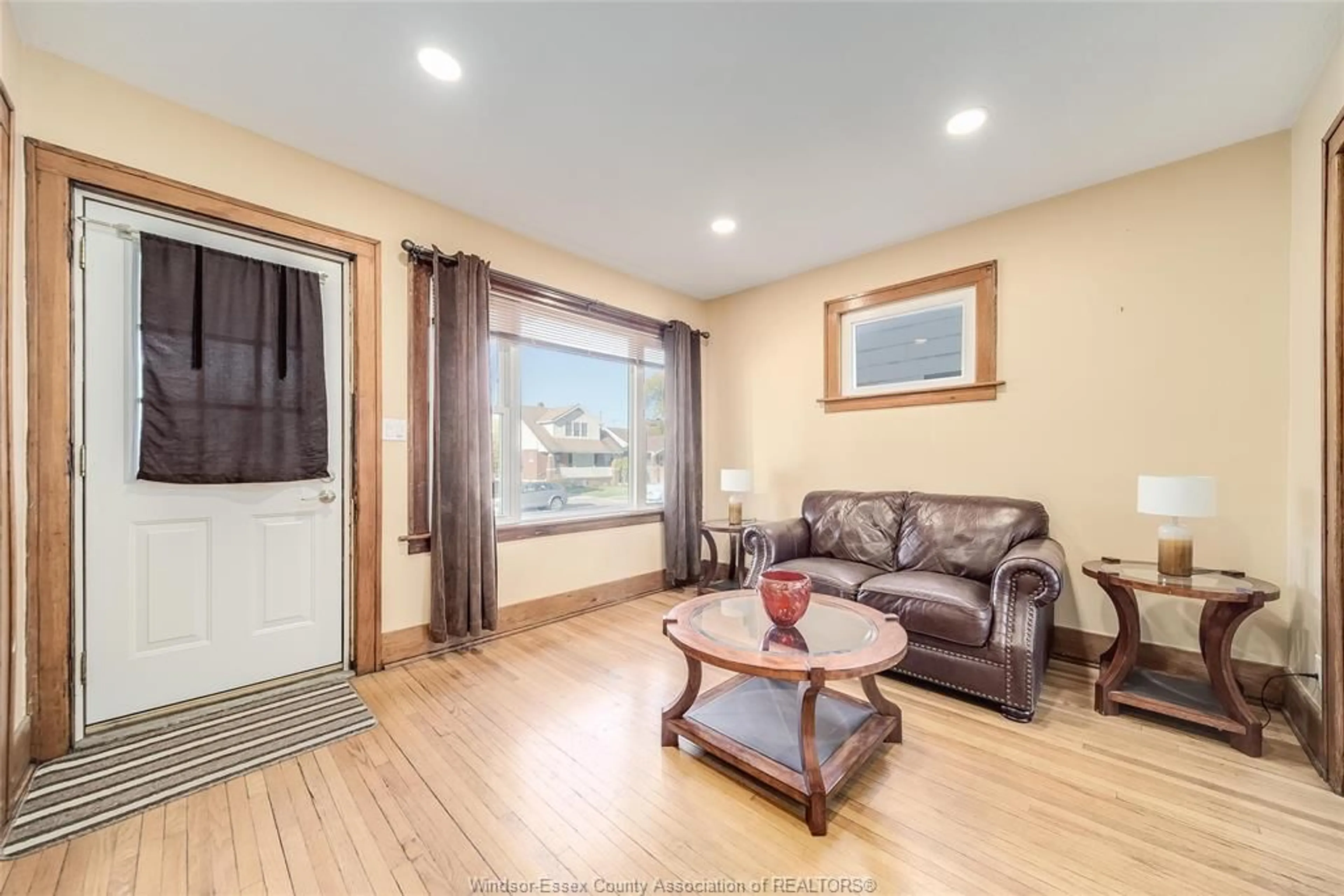 Living room with furniture, wood/laminate floor for 1640 PILLETTE Rd, Windsor Ontario N8Y 3C5