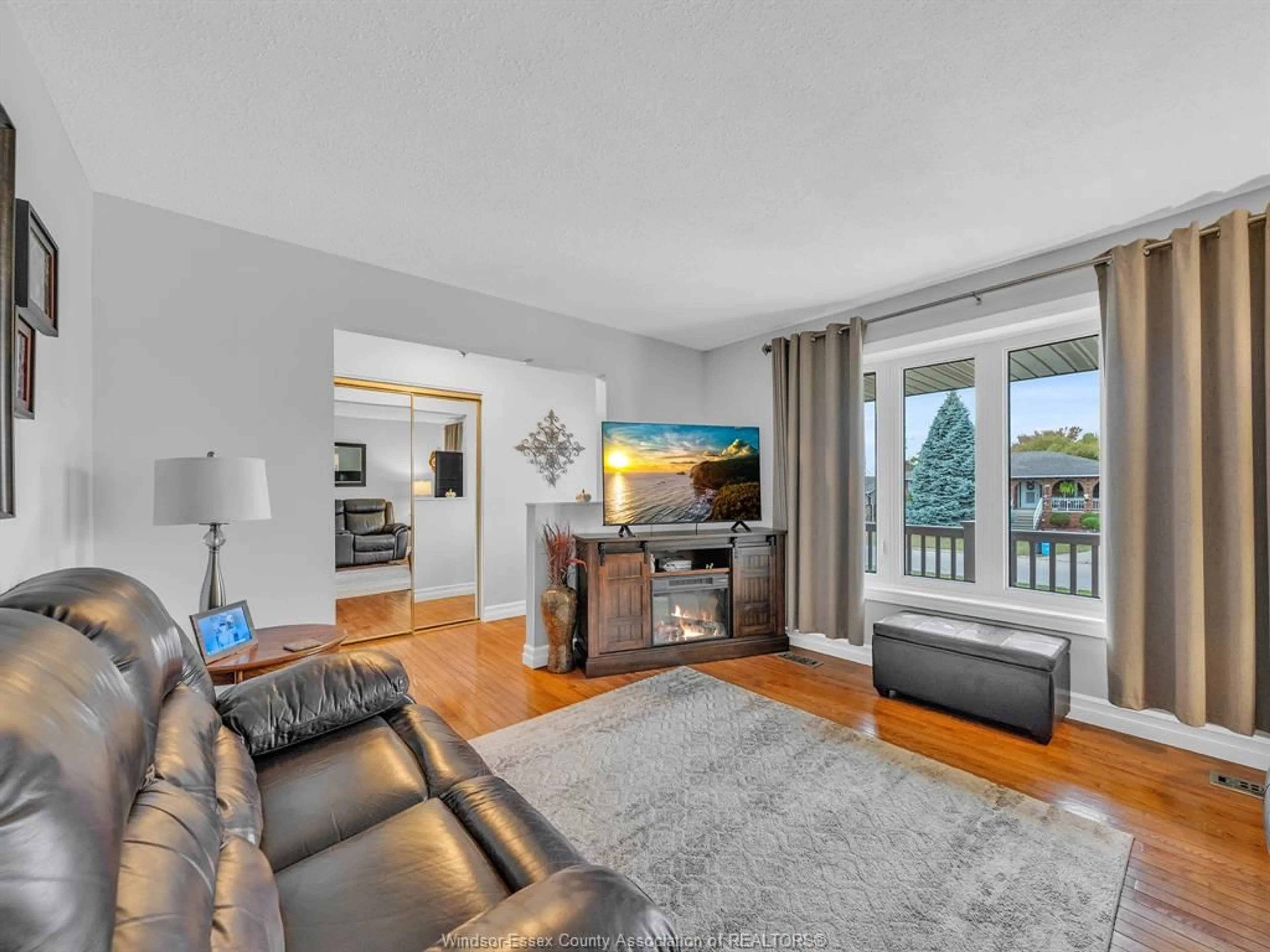 Living room with furniture, wood/laminate floor for 34 STATES, Amherstburg Ontario N9V 3M2