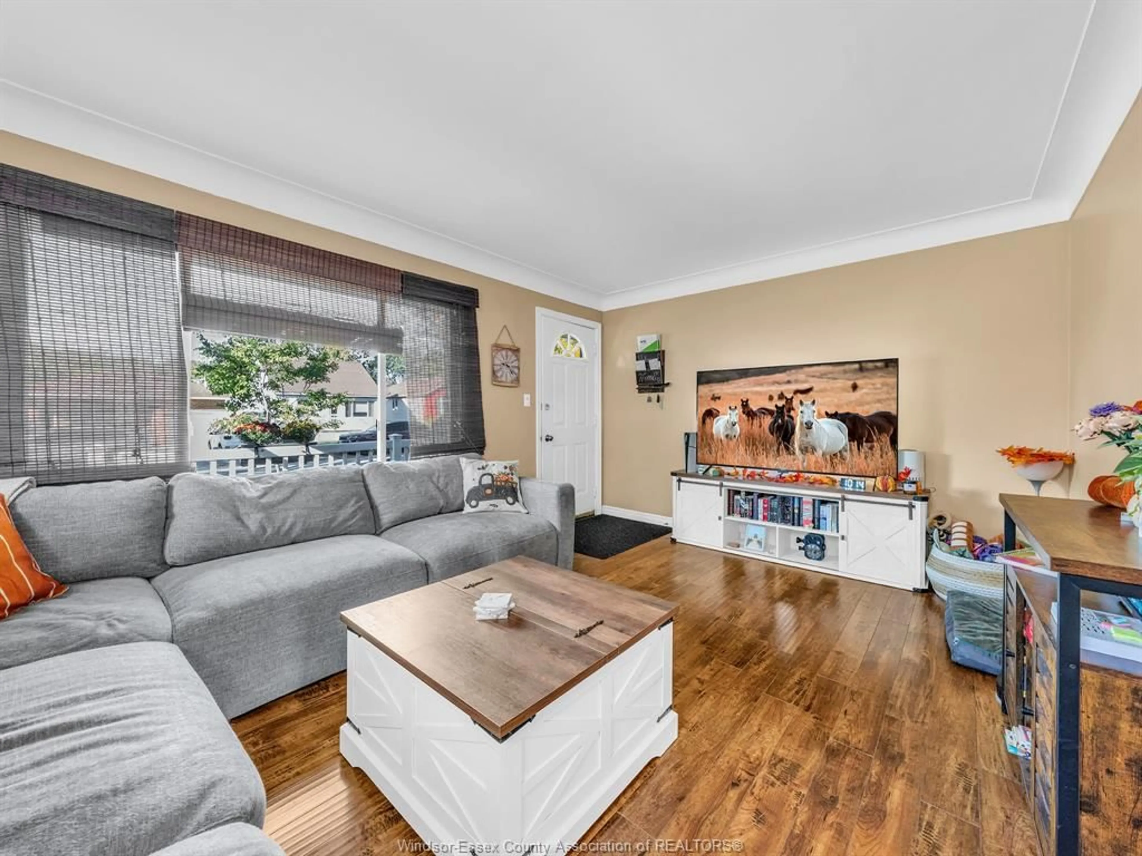 Living room with furniture, wood/laminate floor for 2436 MELDRUM Rd, Windsor Ontario N8W 4E8