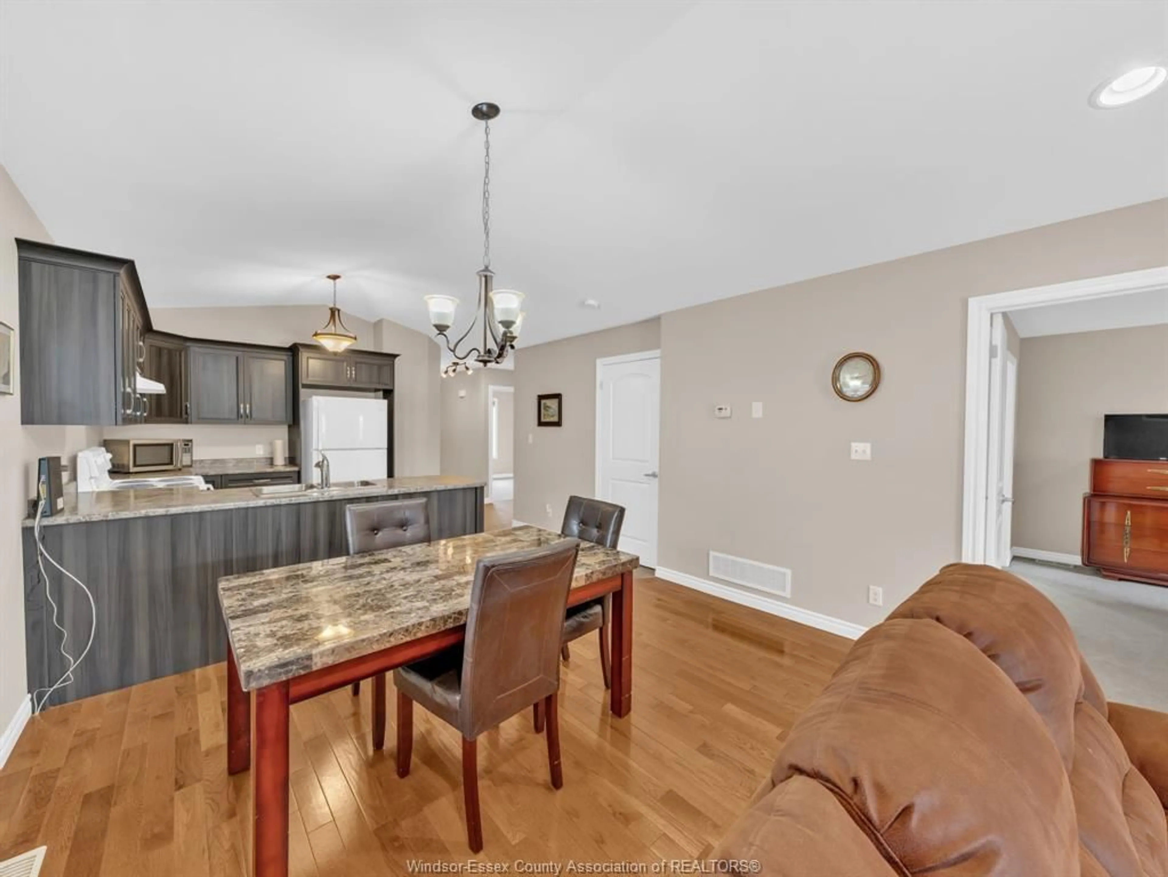 Open concept kitchen, wood/laminate floor for 3205 Seville, Windsor Ontario N8N 0A3