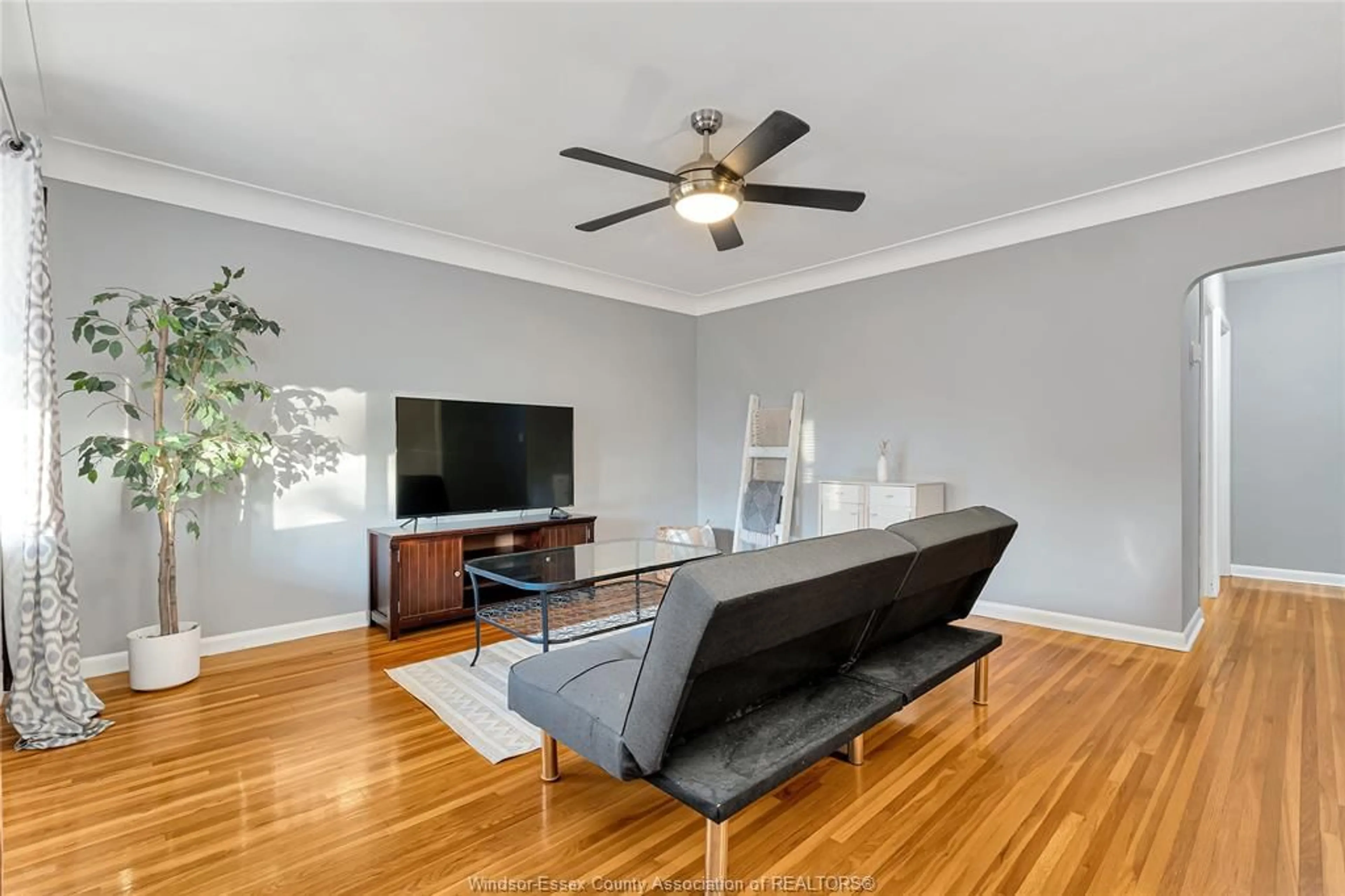 Living room with furniture, wood/laminate floor for 3891 VAUGHAN St, Windsor Ontario N9C 1Z6