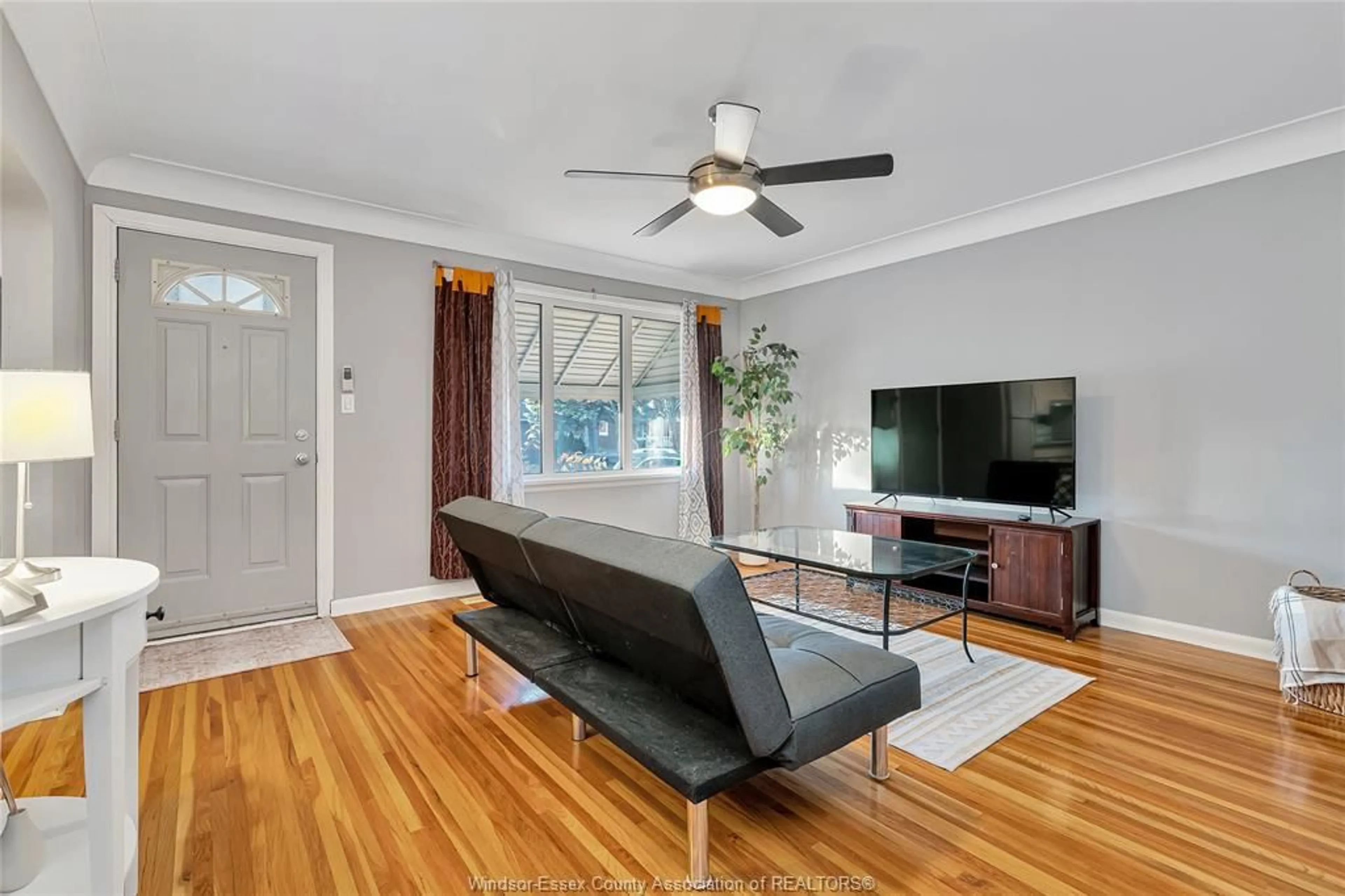 Living room with furniture, wood/laminate floor for 3891 VAUGHAN St, Windsor Ontario N9C 1Z6