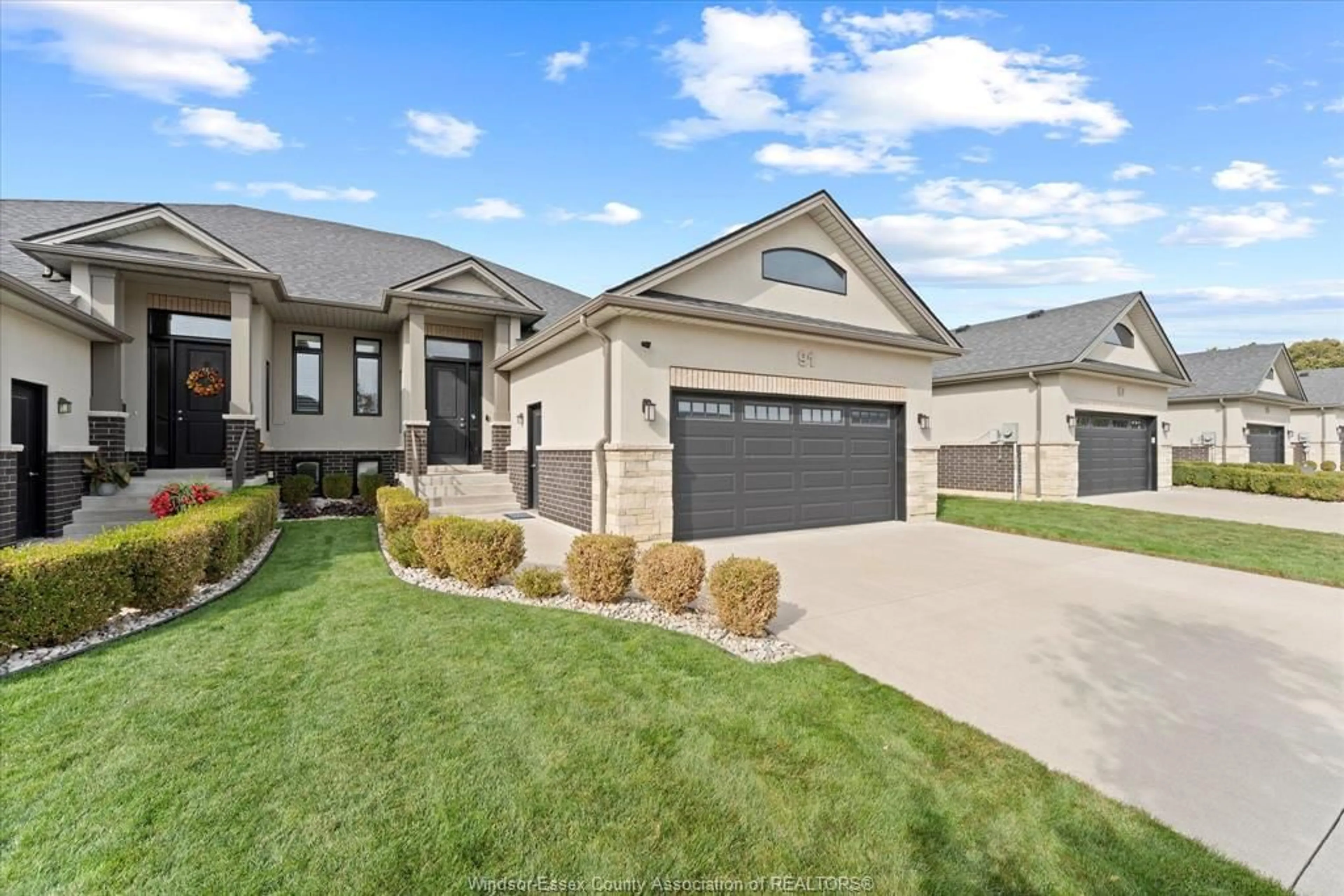 Home with vinyl exterior material, street for 91 CAROLINA WOODS Cres, Leamington Ontario N8H 5N2