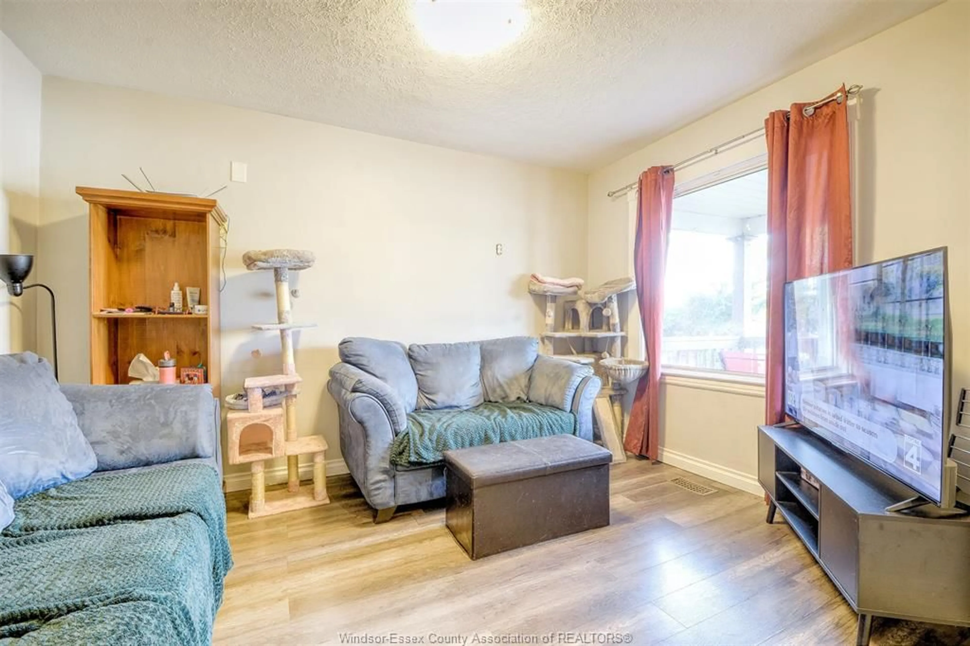 Living room with furniture, wood/laminate floor for 1143 Langlois, Windsor Ontario N8X 3L3