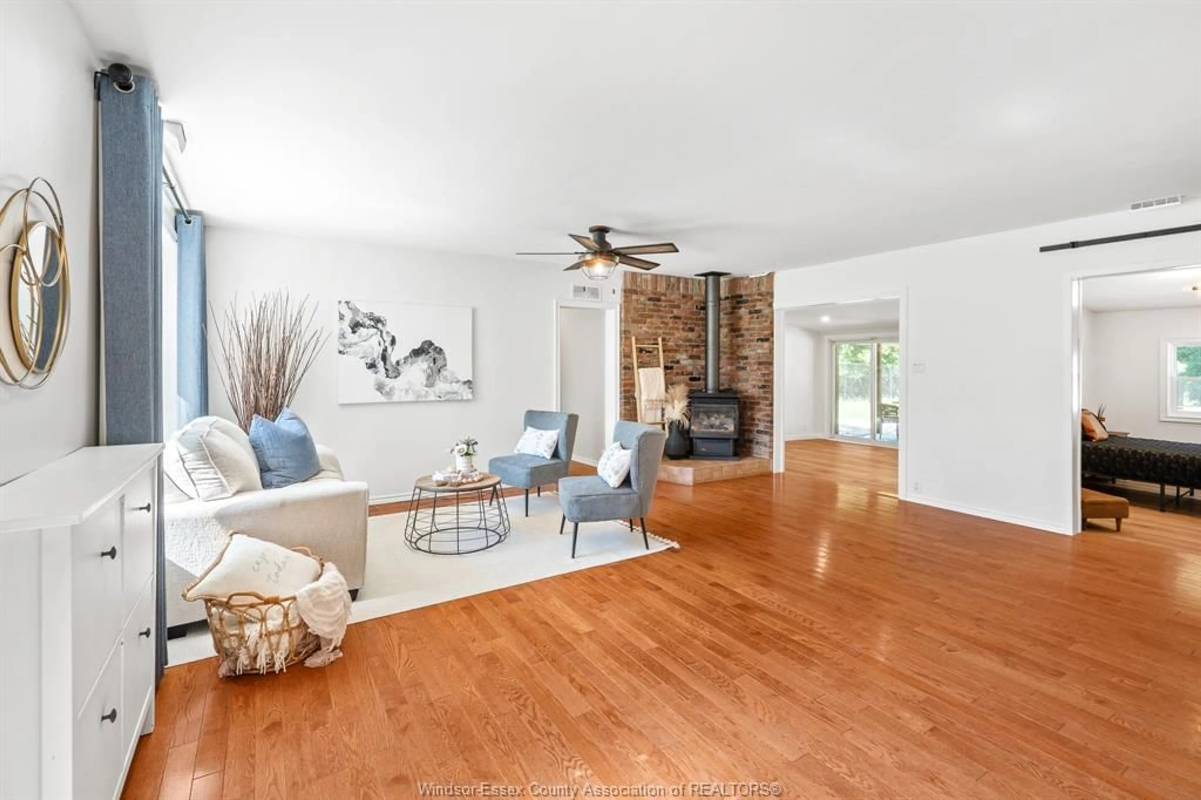 Living room with furniture, wood/laminate floor for 9395 River Line, Chatham Ontario N7M 5J4