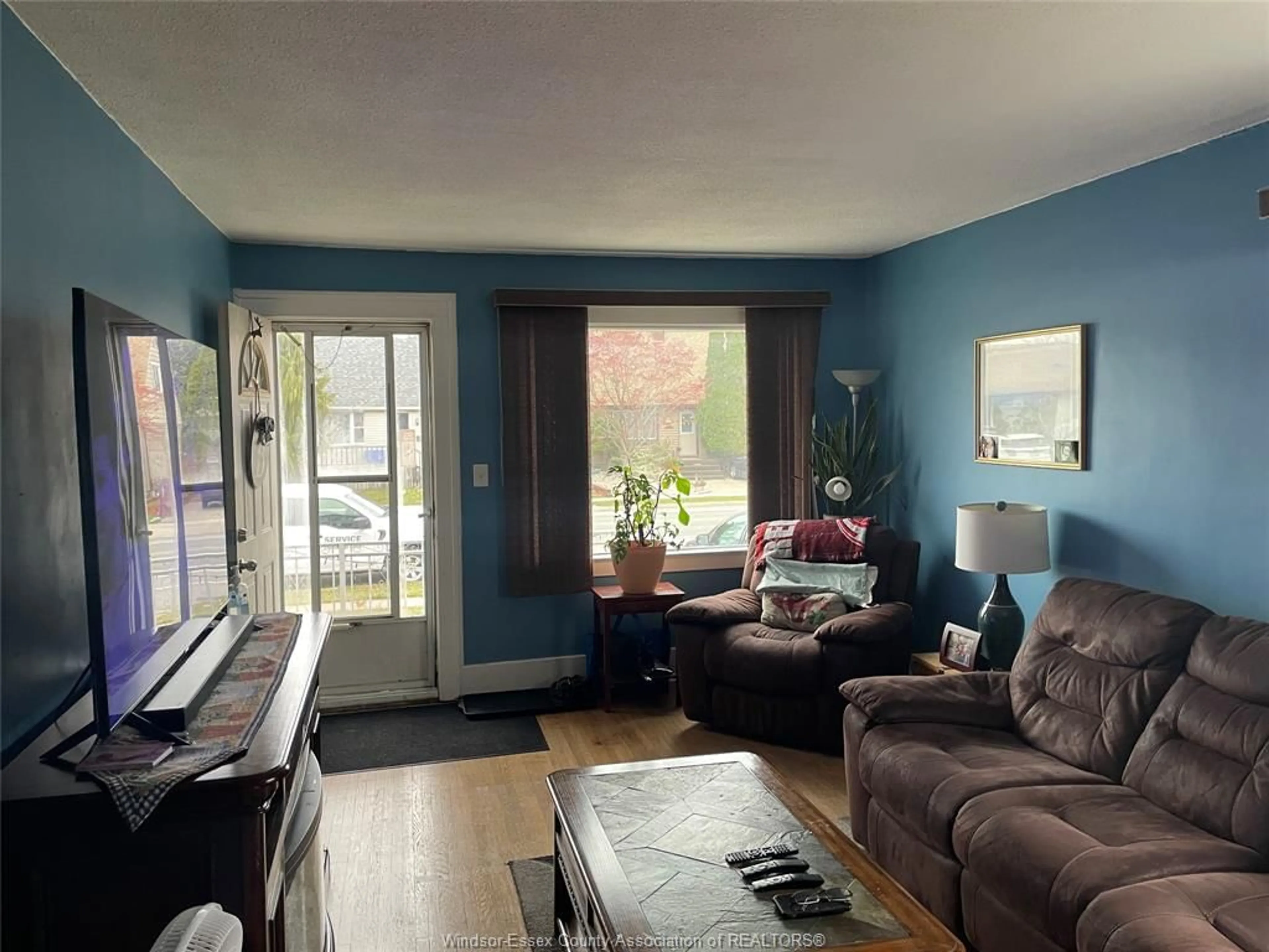 Living room with furniture, wood/laminate floor for 1673 Pillette Rd, Windsor Ontario N8Y 3C4