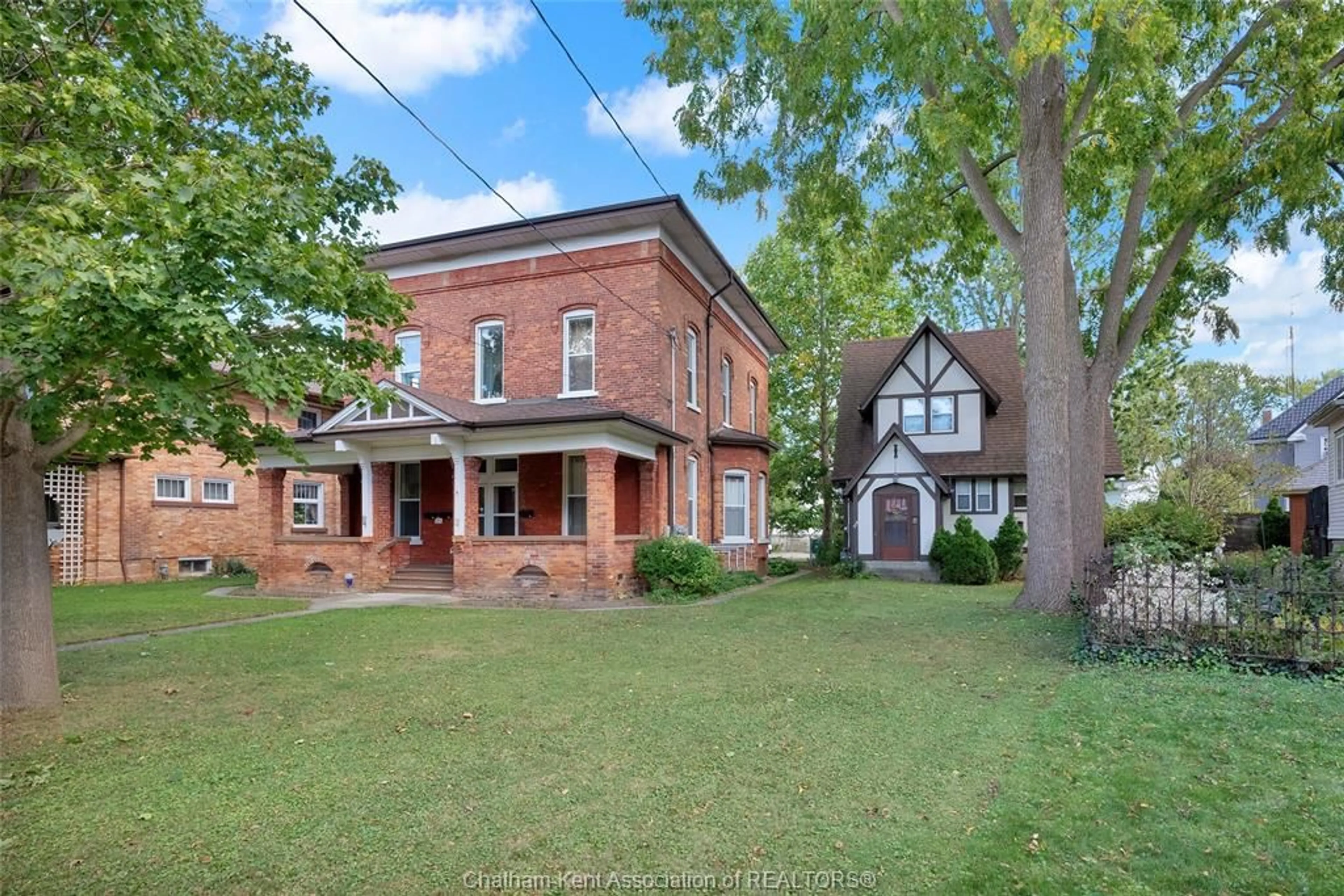 Home with brick exterior material, street for 310, 312, 318 Wellington St, Chatham Ontario N7M 1K1
