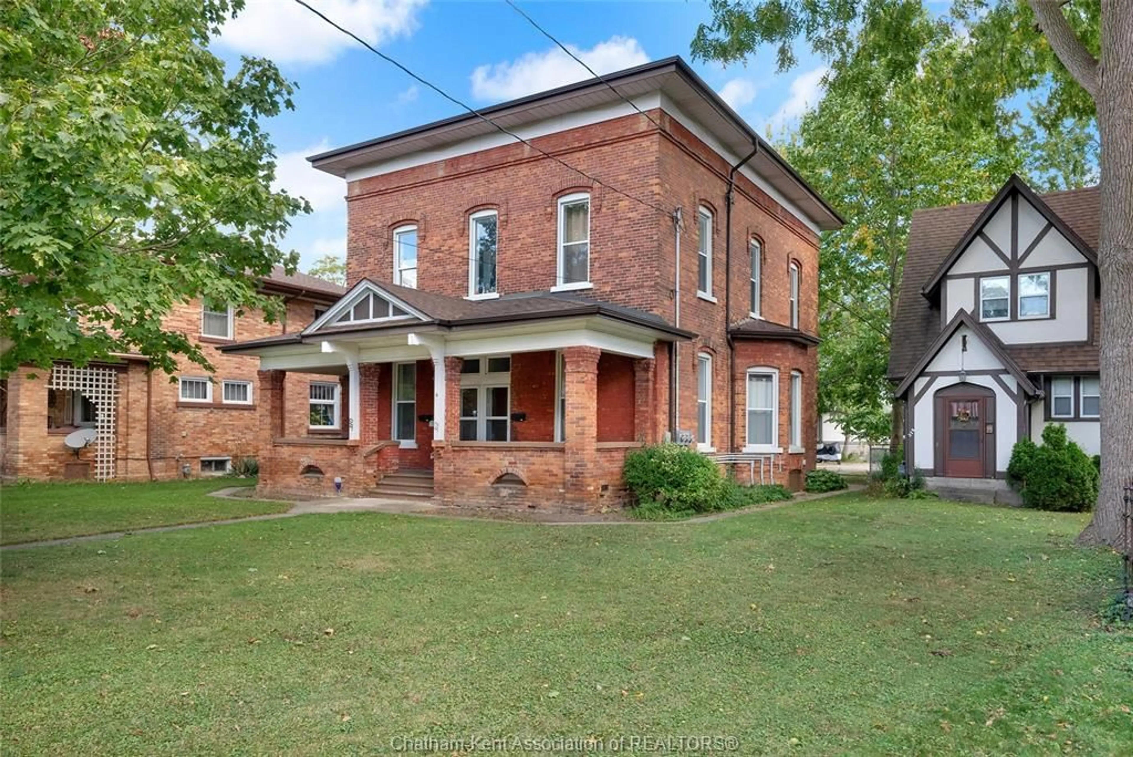 Home with brick exterior material, building for 310, 312, 318 Wellington St, Chatham Ontario N7M 1K1