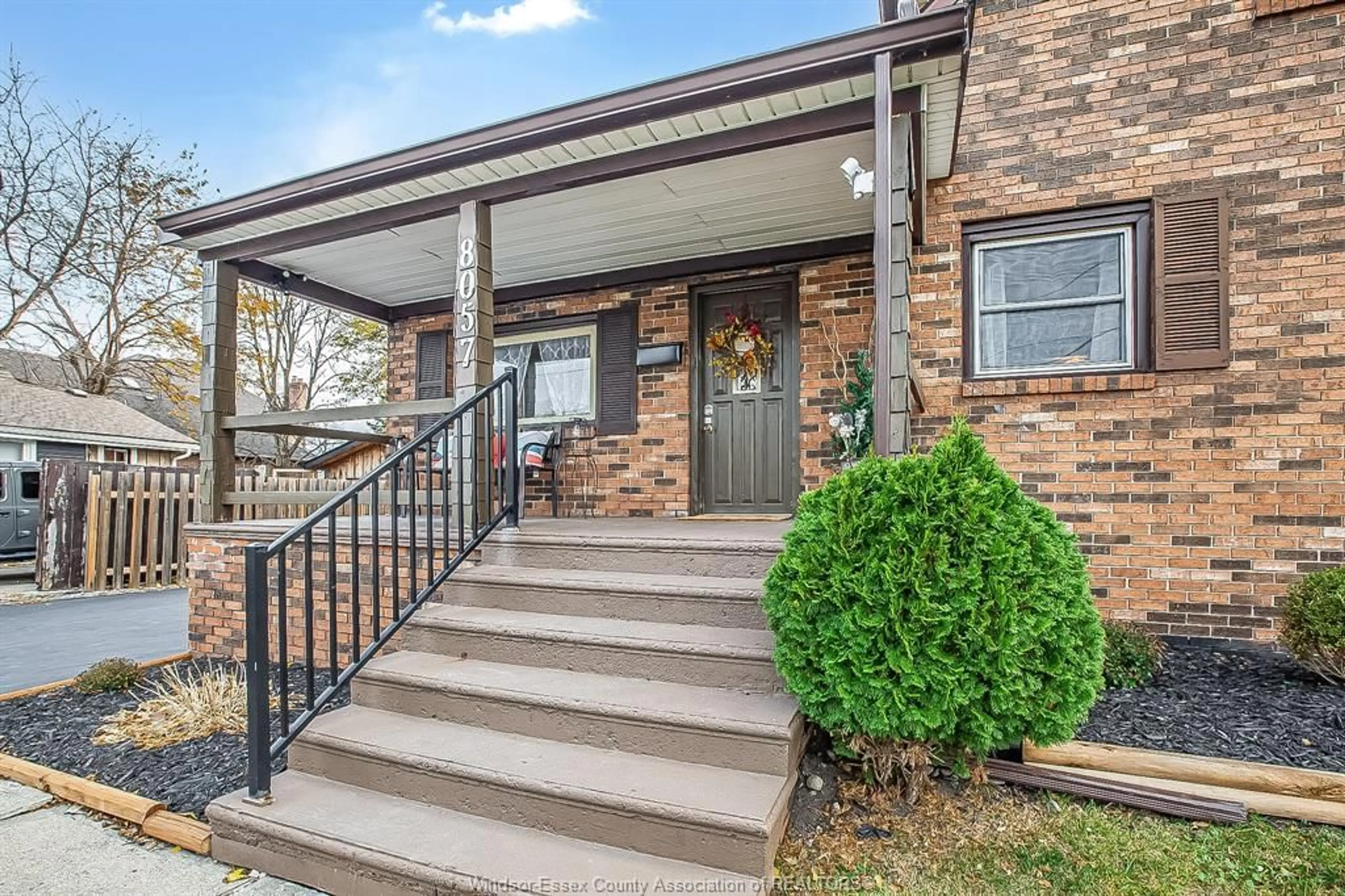 Home with brick exterior material, street for 8057 RIVERSIDE Dr, Windsor Ontario N8S 1E5