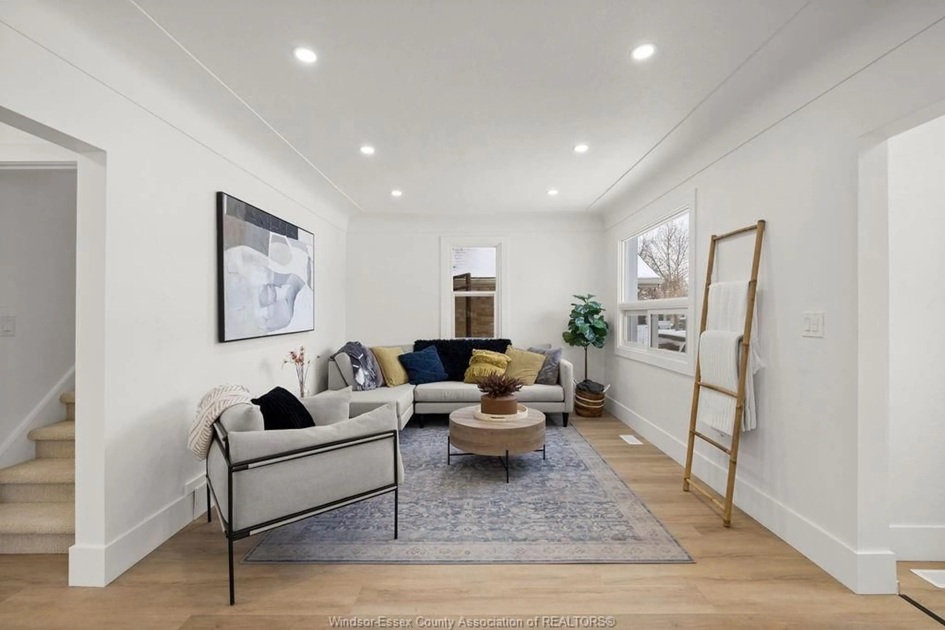 Living room with furniture, wood/laminate floor for 2420 TOURANGEAU Rd, Windsor Ontario N8W 4N7