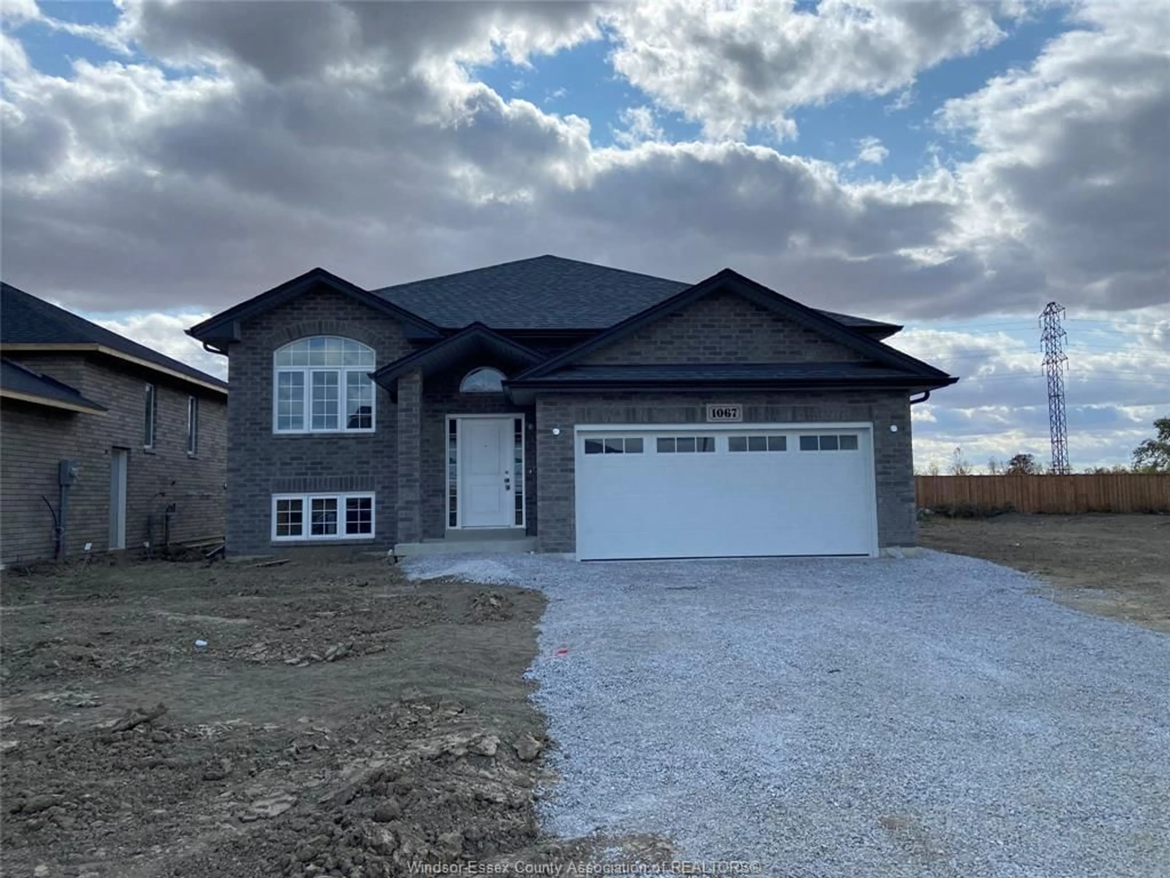 Home with brick exterior material, street for 1067 ASPEN RIDGE Cres, Lakeshore Ontario N0R 1A0