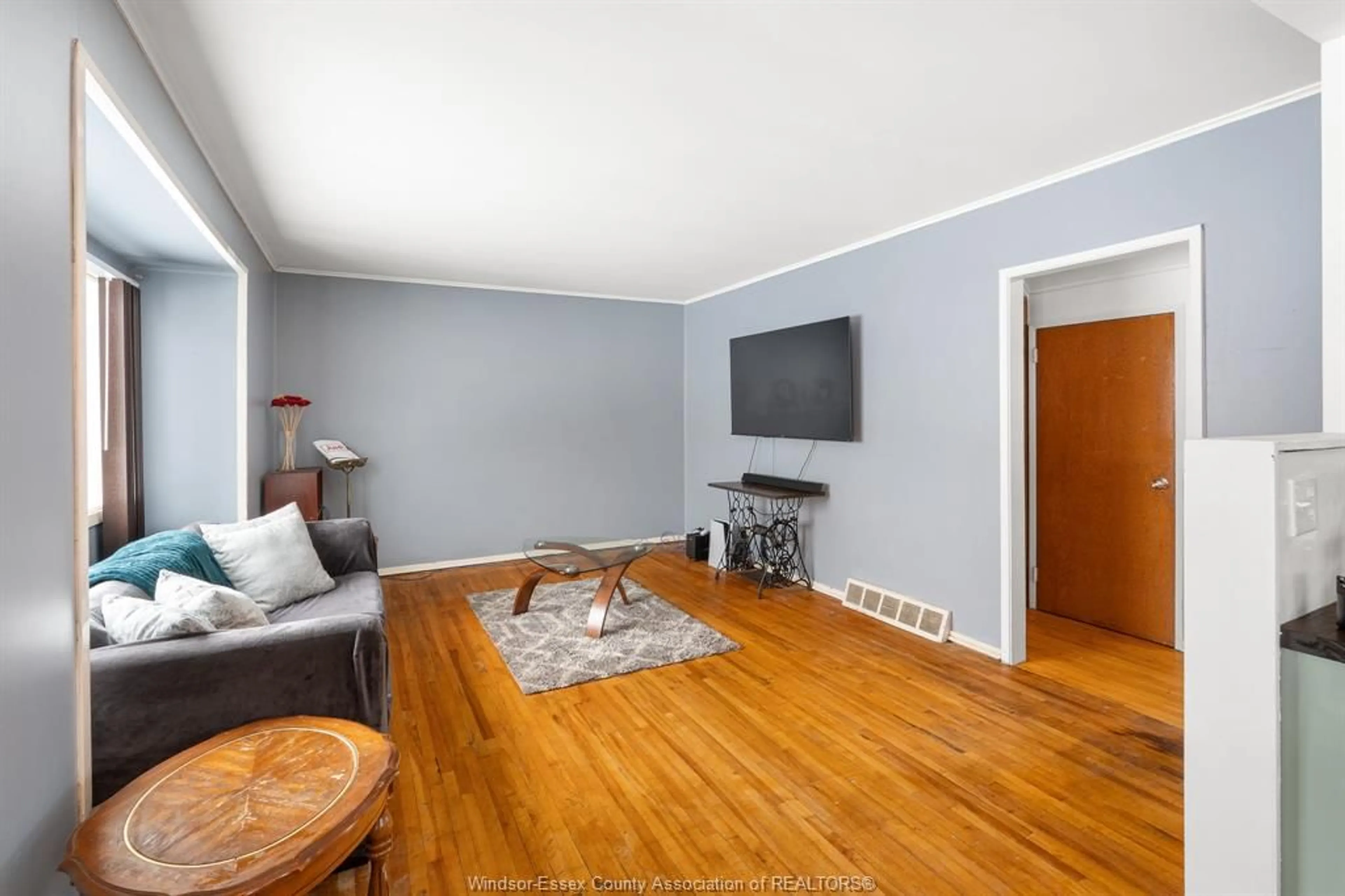 Living room with furniture, wood/laminate floor for 1883 LARKIN RD, Windsor Ontario N8W 4G7