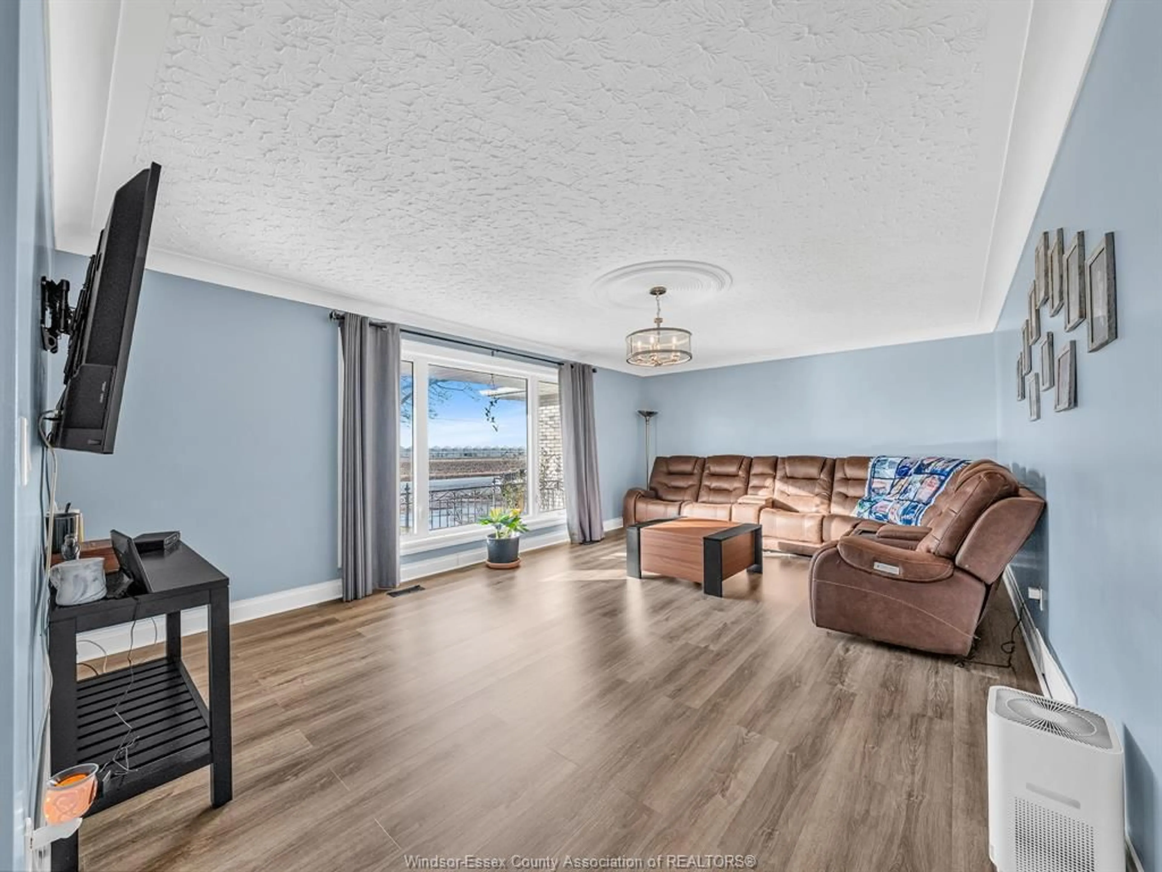 Living room with furniture, wood/laminate floor for 1502 Road 4 East, Ruthven Ontario N0P 2G0