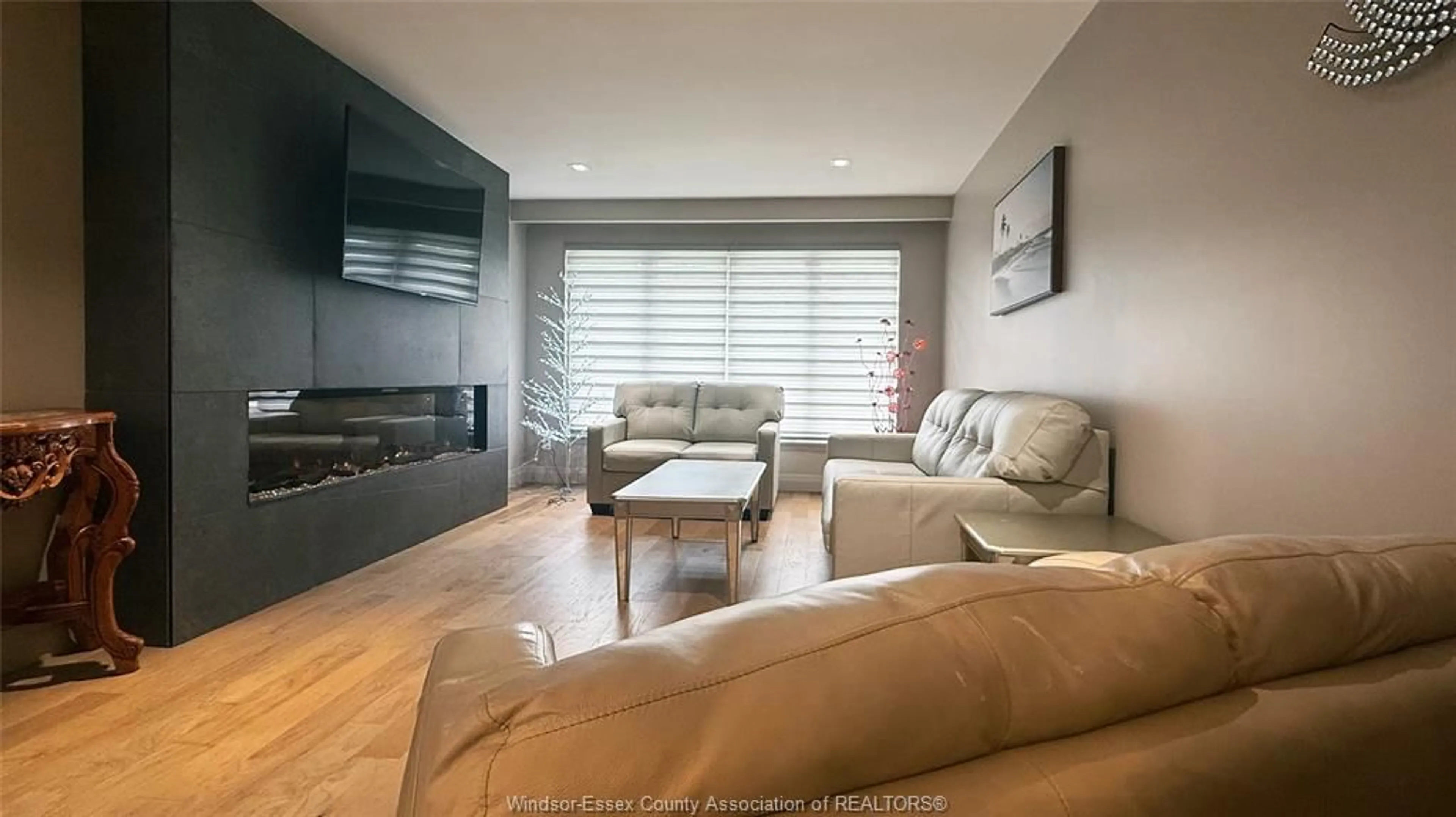 Living room with furniture, wood/laminate floor for 9793 LYNNGROVE Cres, Windsor Ontario N8R 1B8