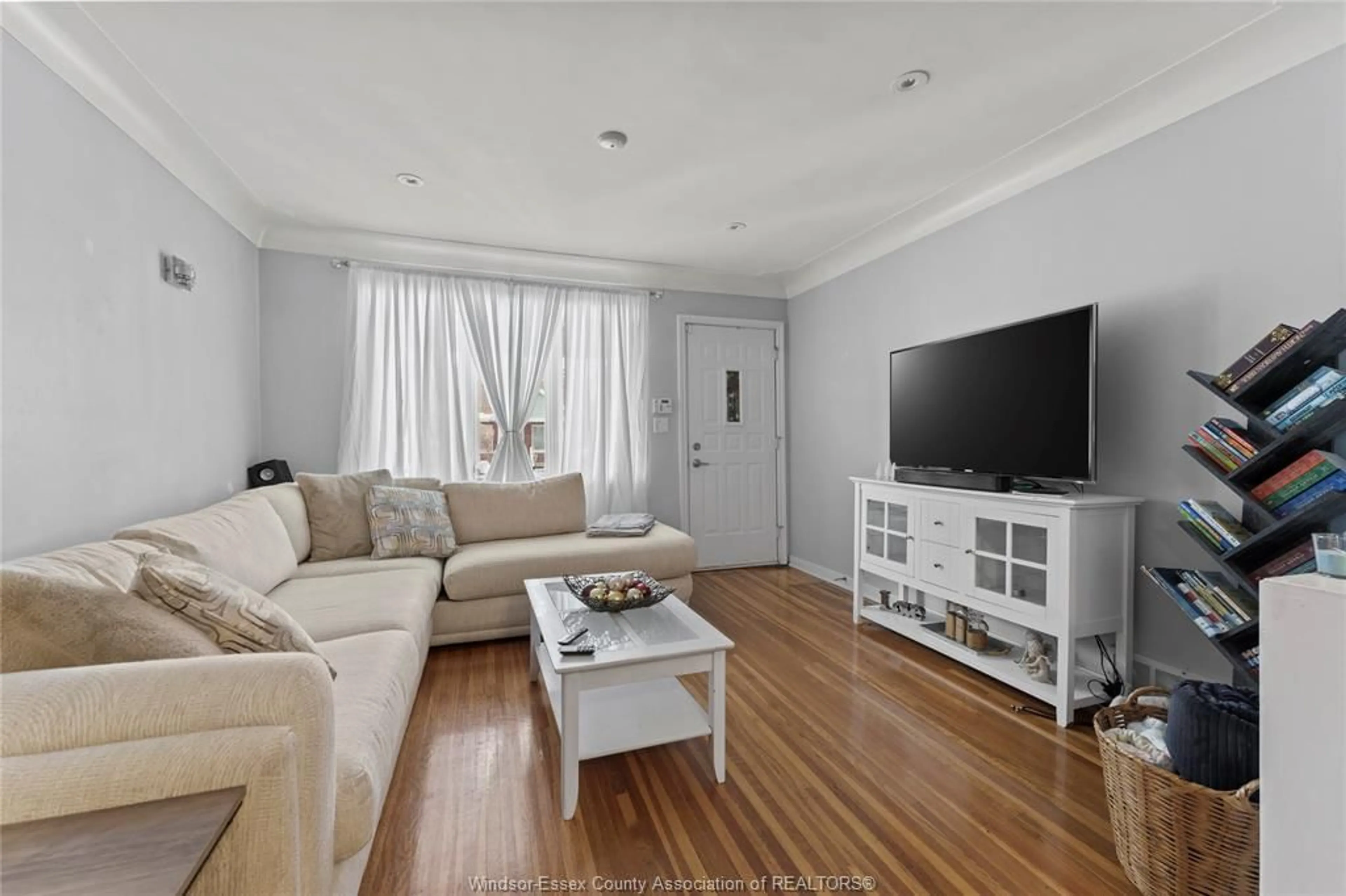 Living room with furniture, wood/laminate floor for 1366 Moy Ave, Windsor Ontario N8X 4S6