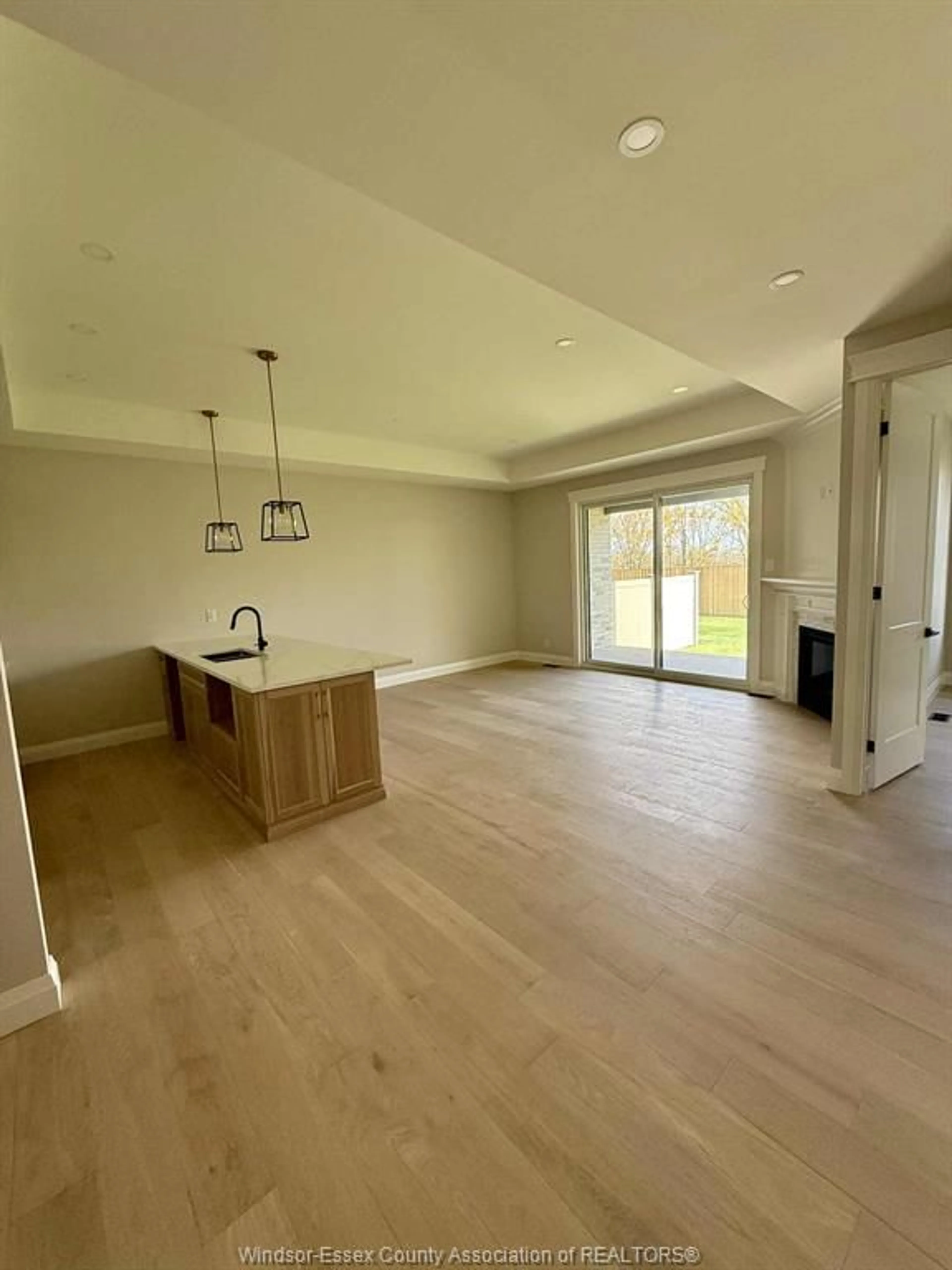 Open concept kitchen, wood/laminate floor for 428 CASERTA Cres, Lakeshore Ontario N0R 1A0