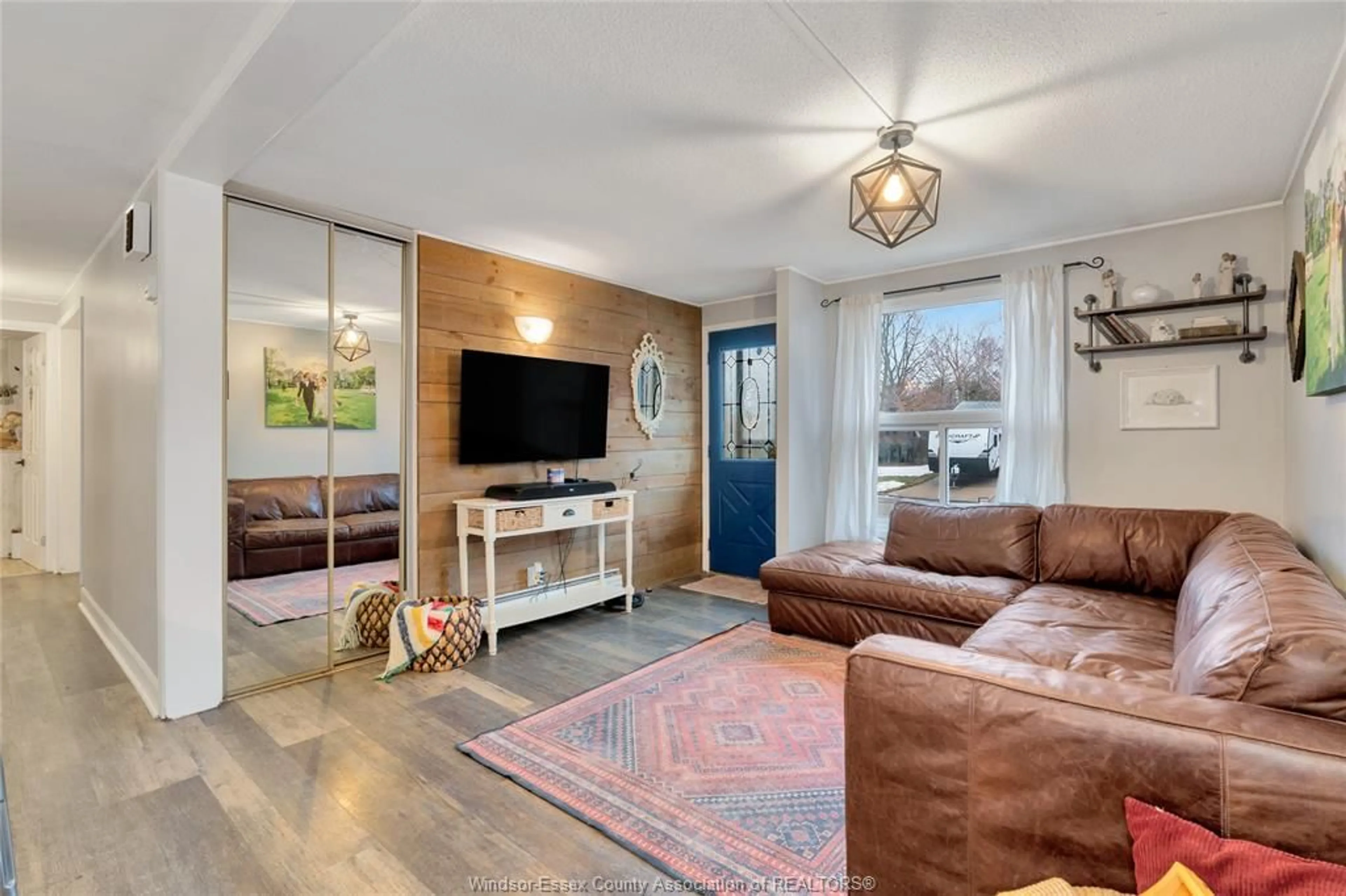 Living room with furniture, wood/laminate floor for 10260 CALEDON Crt, Windsor Ontario N8R 1C6