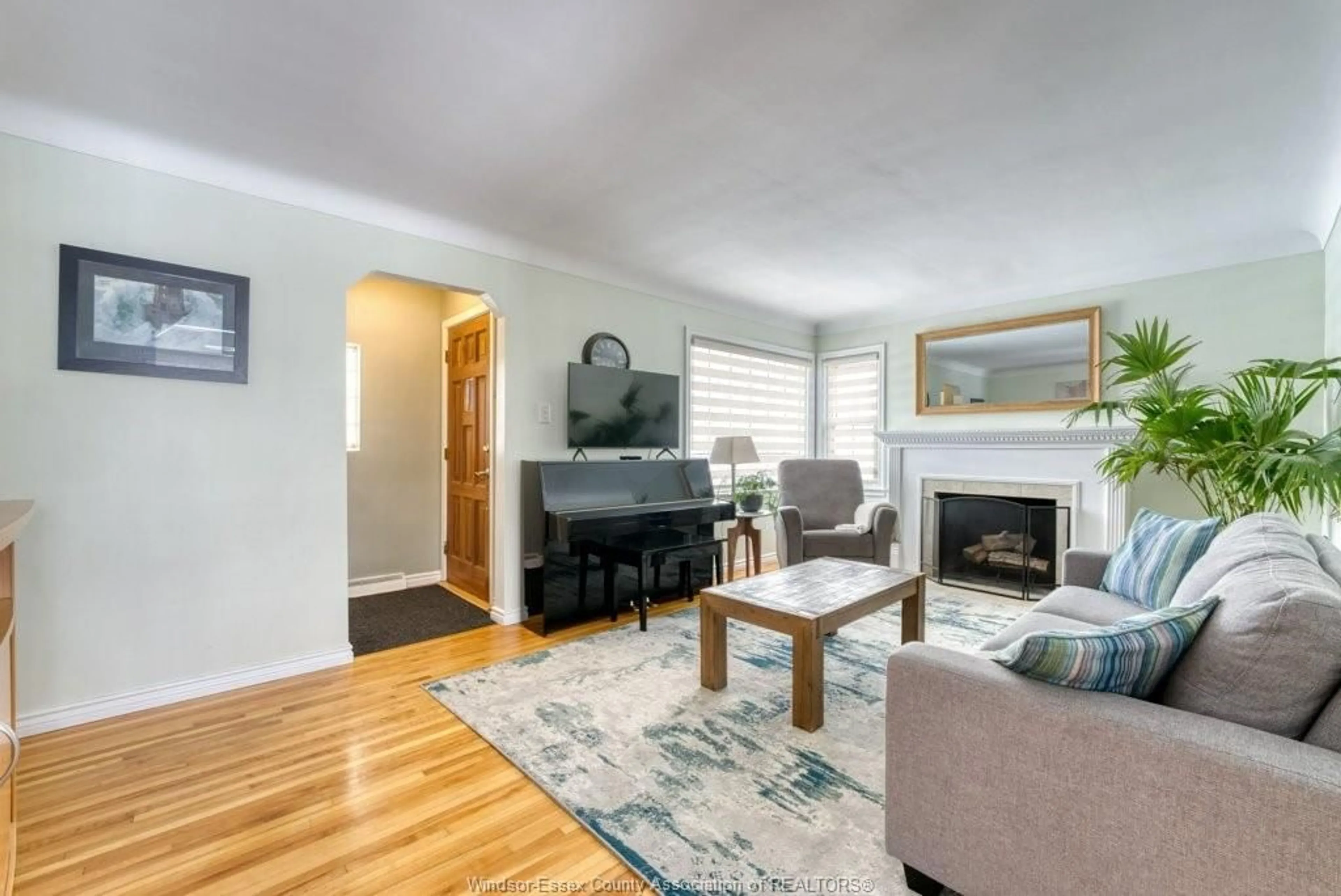 Living room with furniture, wood/laminate floor for 2580 Byng Rd, Windsor Ontario N8W 3E9