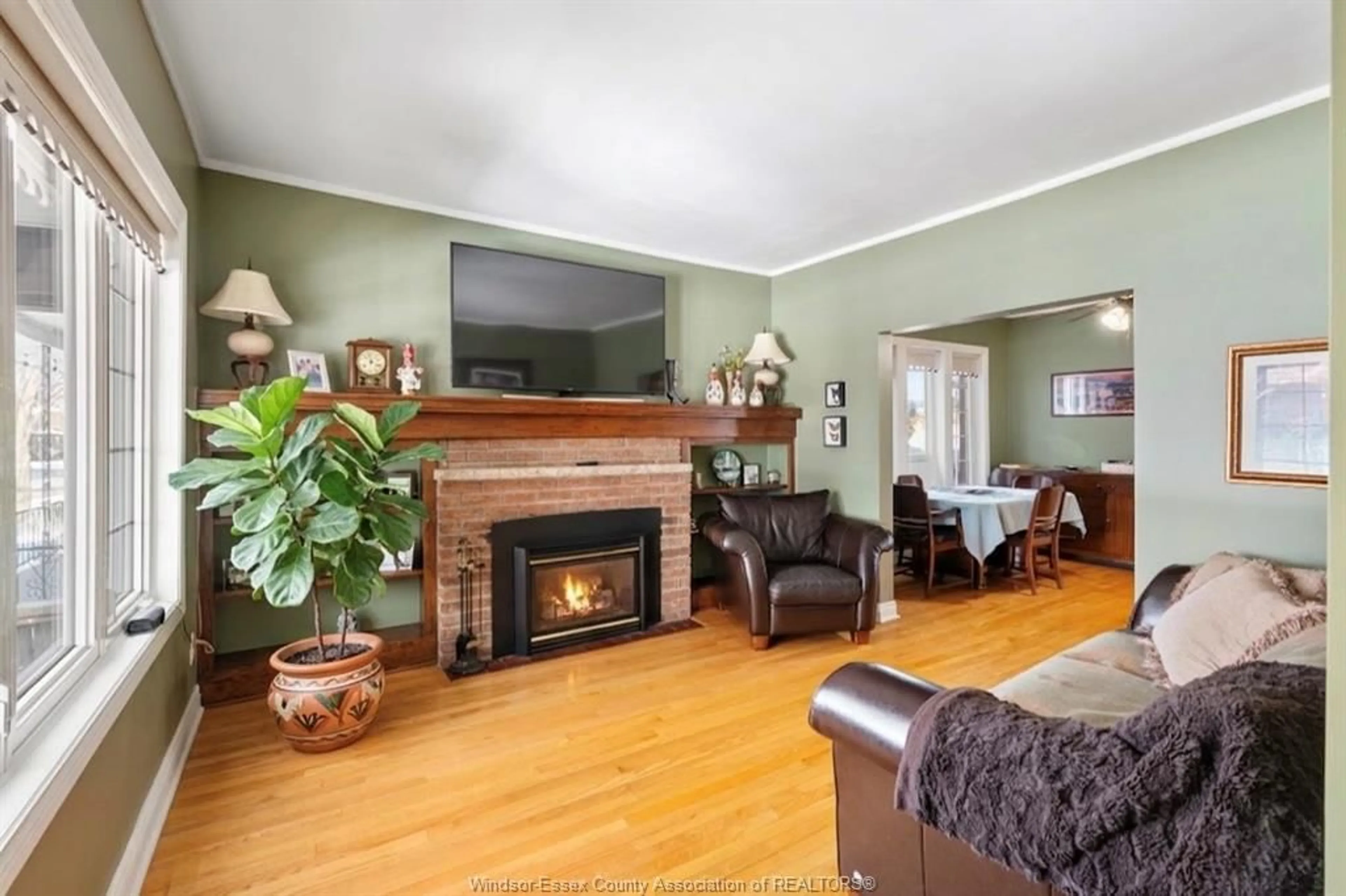 Living room with furniture, wood/laminate floor for 1566 HALL Ave, Windsor Ontario N8X 4R7