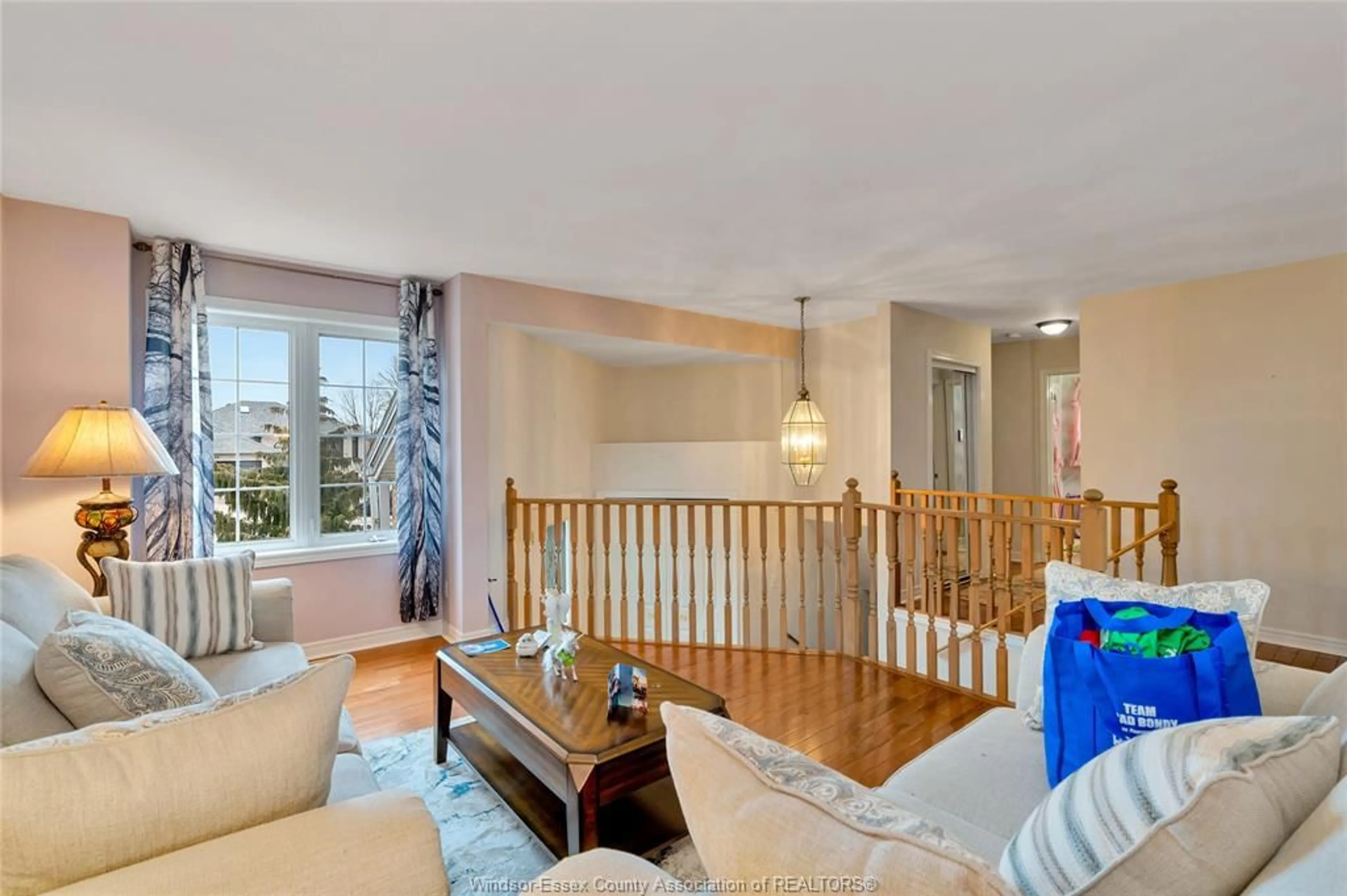 Living room with furniture, wood/laminate floor for 12721 NORTHFIELD Way, Tecumseh Ontario N8N 4W8