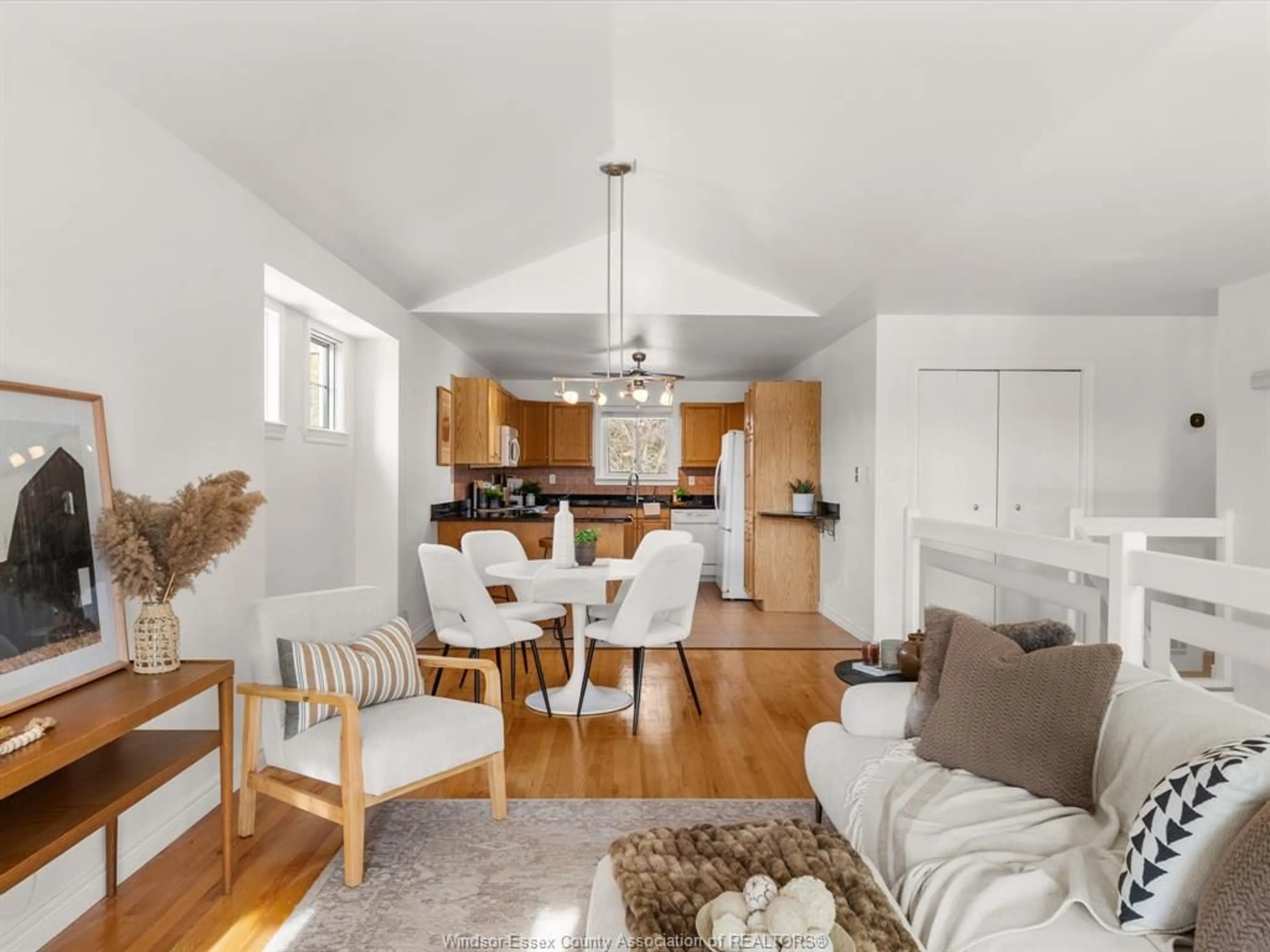 Living room with furniture, wood/laminate floor for 12470 Little River Blvd, Tecumseh Ontario N8N 4V4