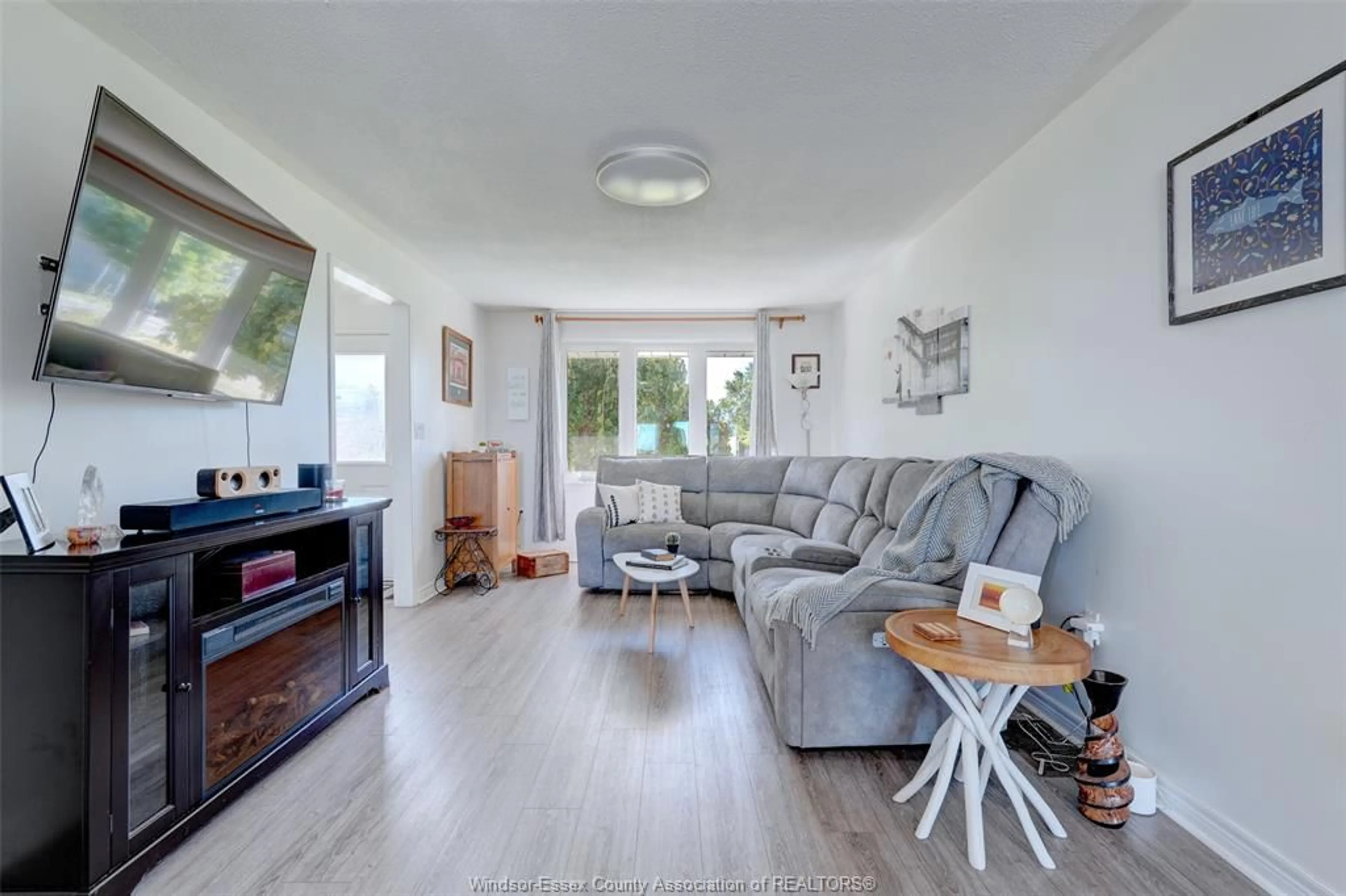 Living room with furniture, wood/laminate floor for 591 ROSS BEACH, Belle River Ontario N8L 1J6