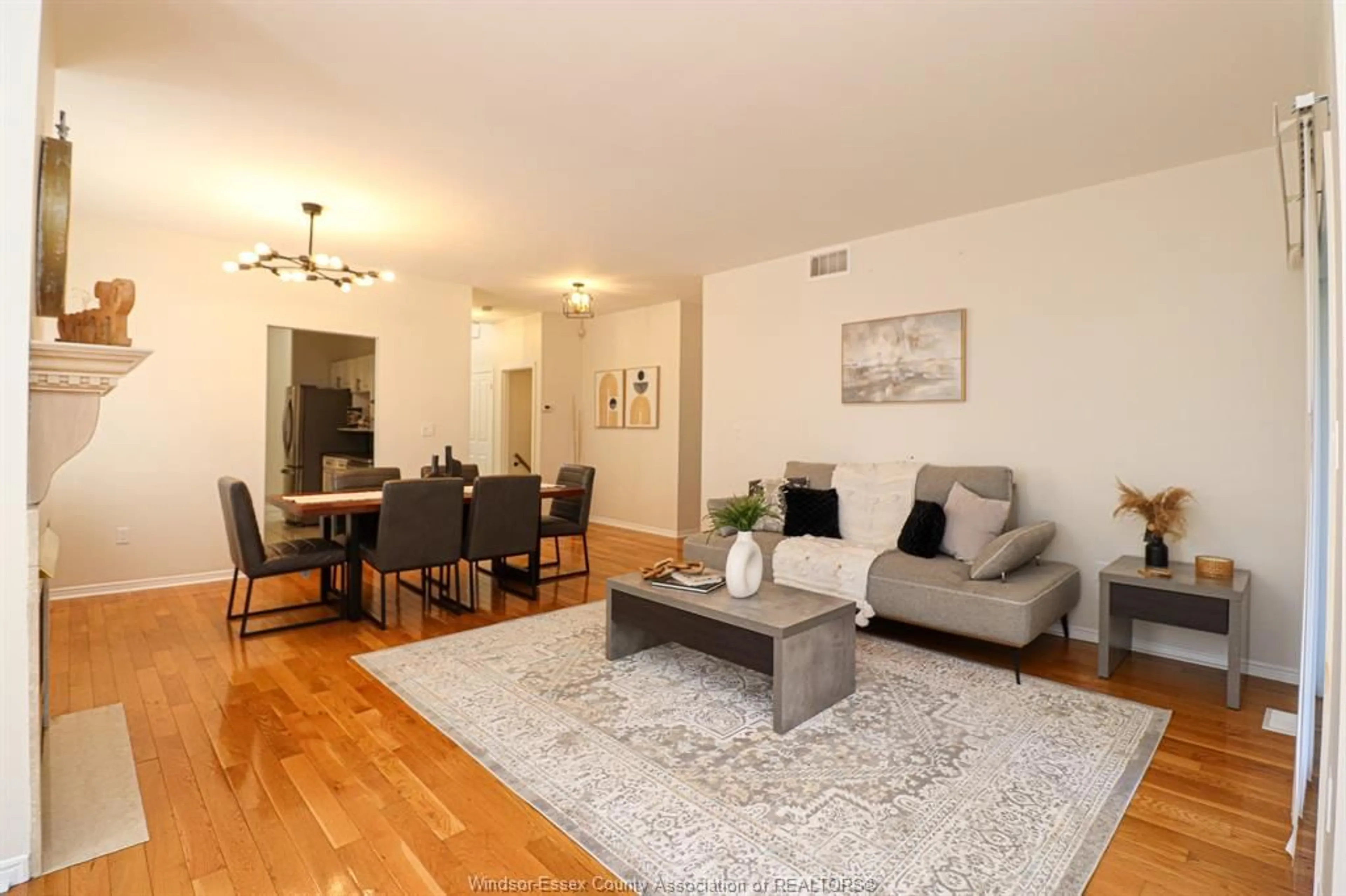 Living room with furniture, wood/laminate floor for 4612 ASCOT Crt, Windsor Ontario N9G 2M1