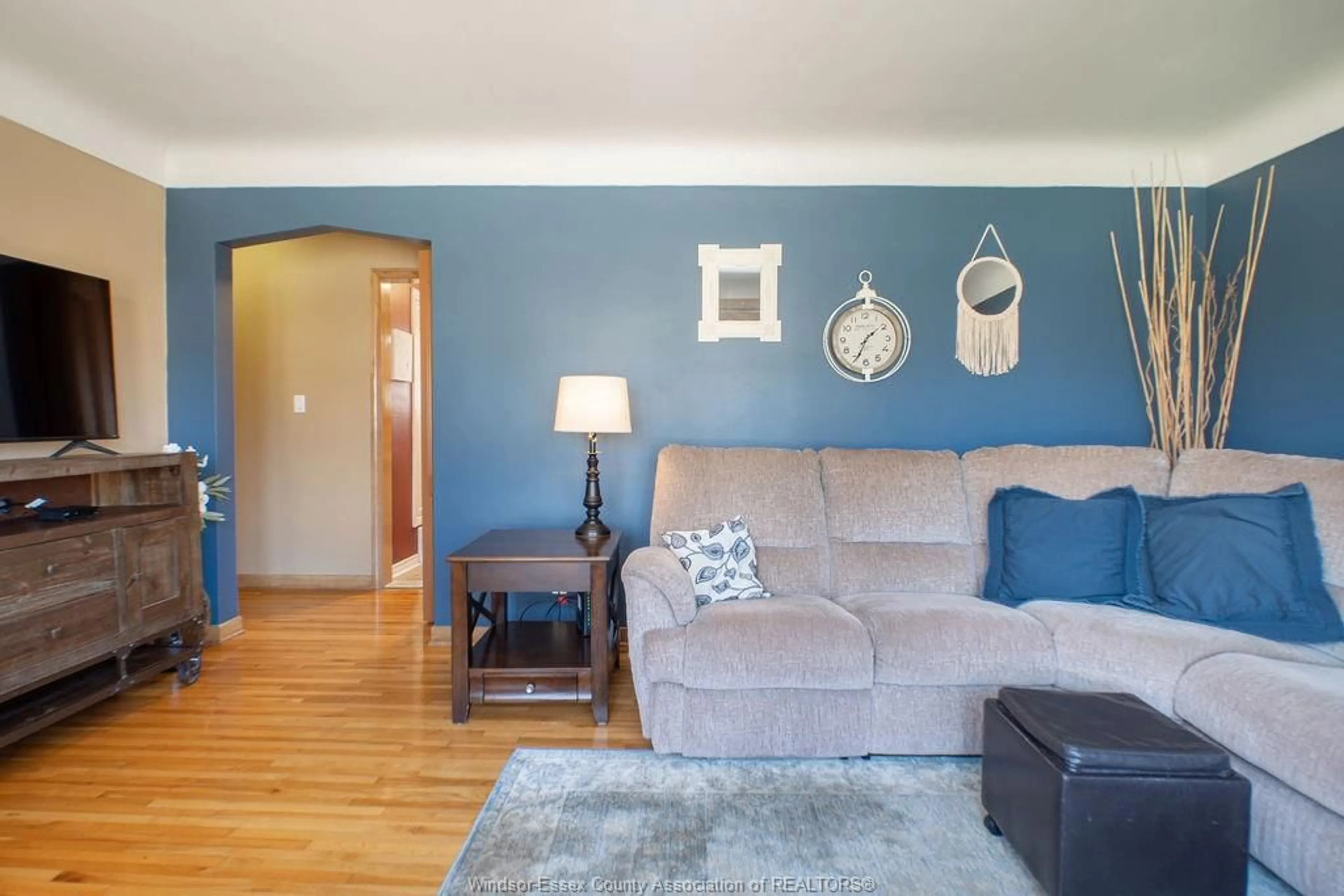 Living room with furniture, wood/laminate floor for 939 Isabelle Pl, Windsor Ontario N8S 3B1