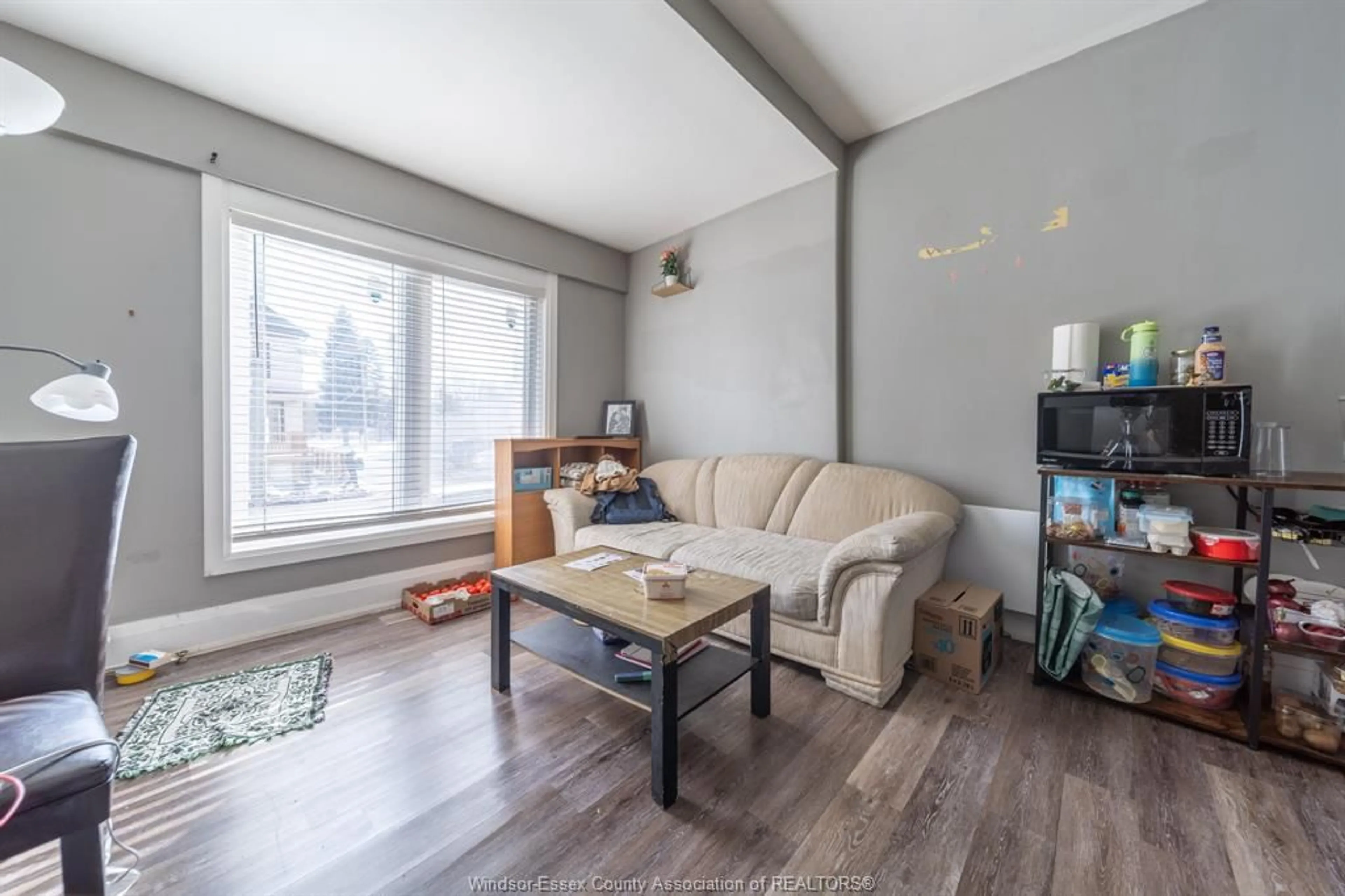 Living room with furniture, wood/laminate floor for 446 WYANDOTTE St, Windsor Ontario N9A 5X4