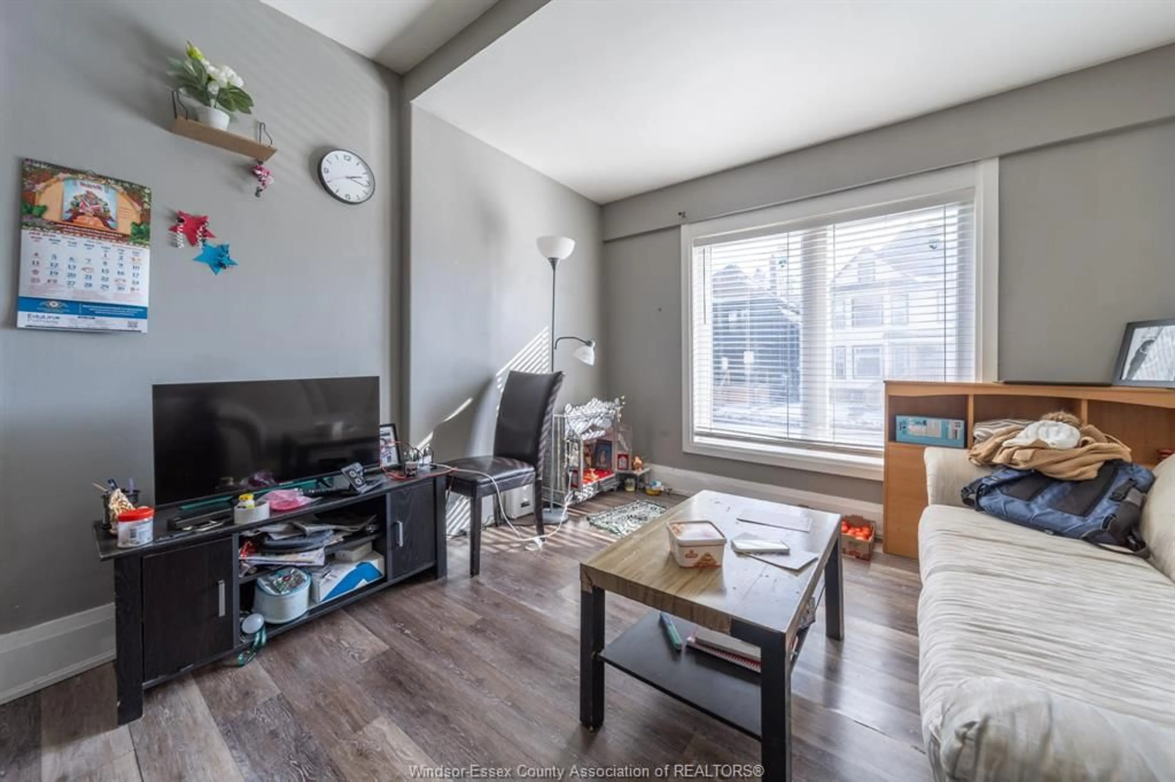 Living room with furniture, wood/laminate floor for 446 WYANDOTTE St, Windsor Ontario N9A 5X4
