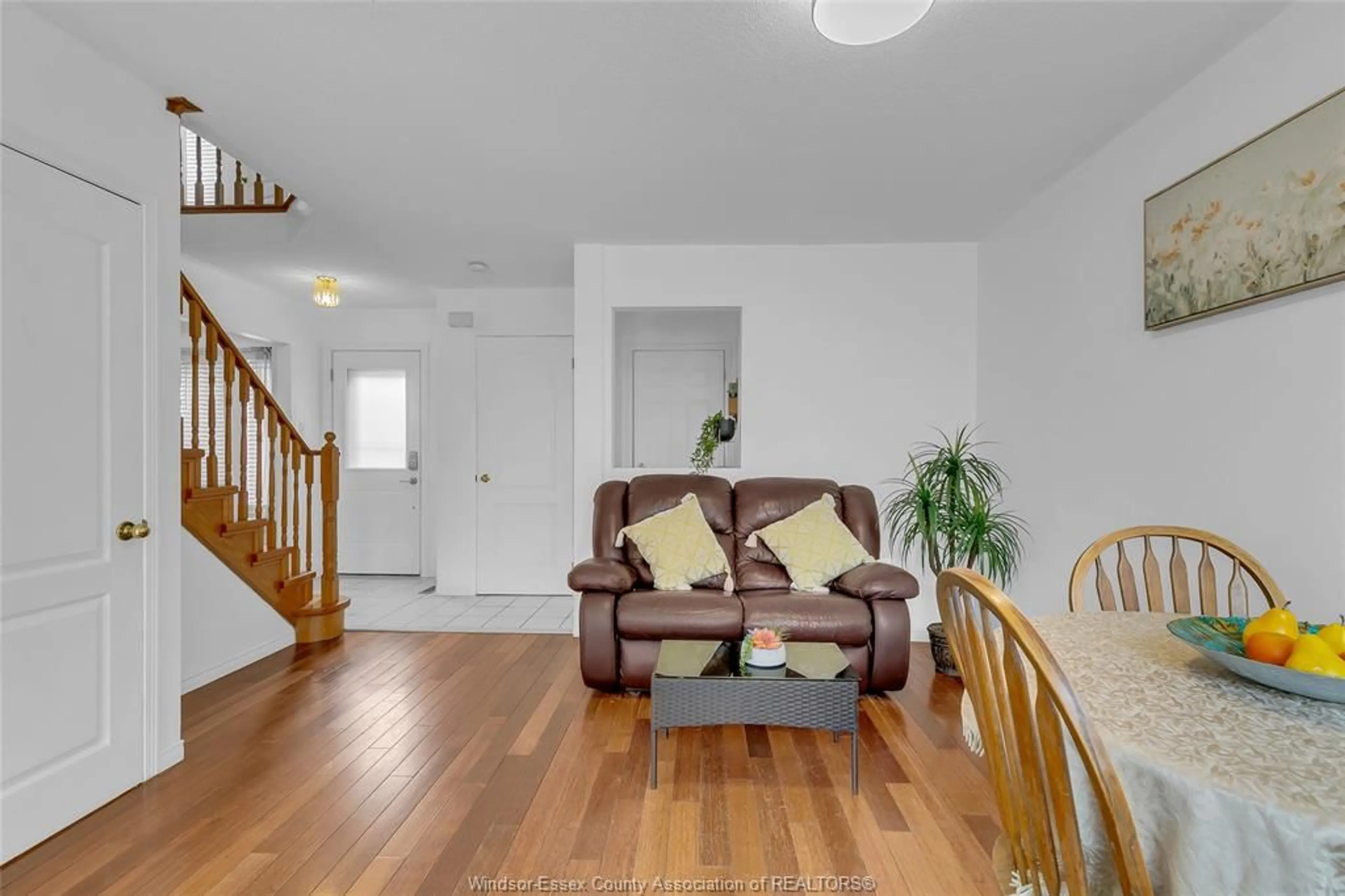 Living room with furniture, wood/laminate floor for 1058 PEACH BLOSSOM Cres, Windsor Ontario N9G 2R5