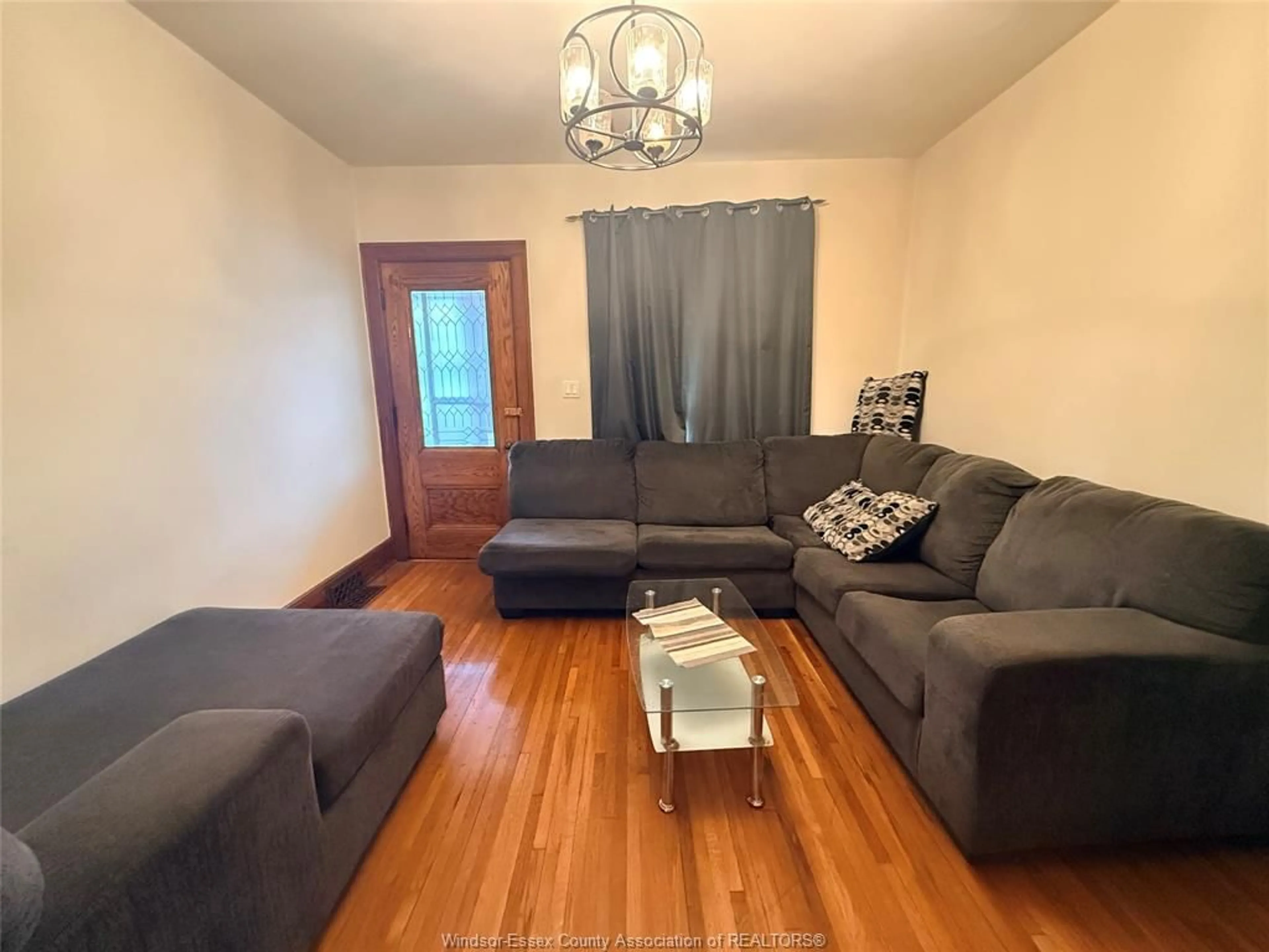 Living room with furniture, wood/laminate floor for 1378 ERIE St, Windsor Ontario N9A 3Z7