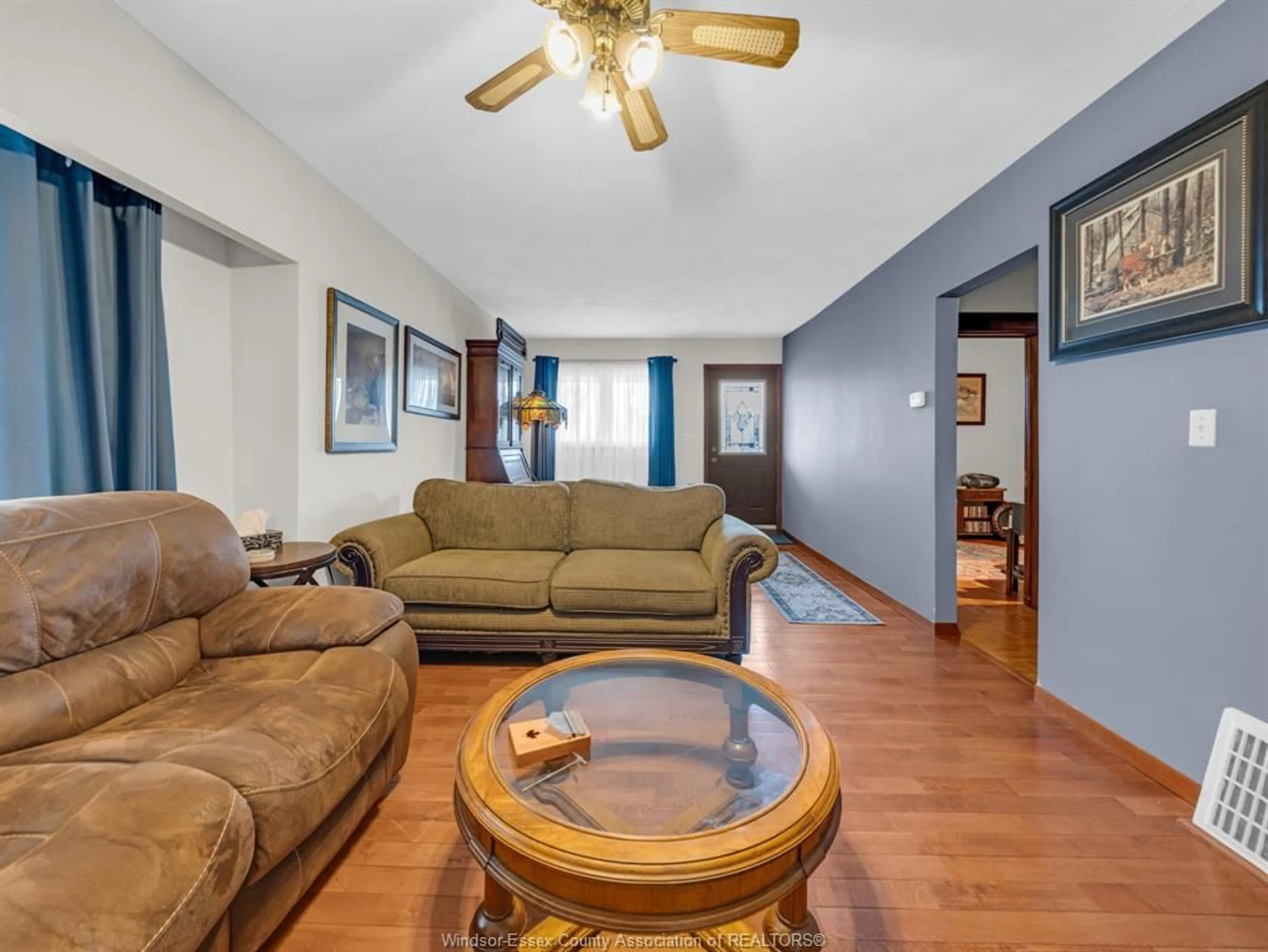 Living room with furniture, wood/laminate floor for 24 Melrose Ave, Leamington Ontario N8H 2H8