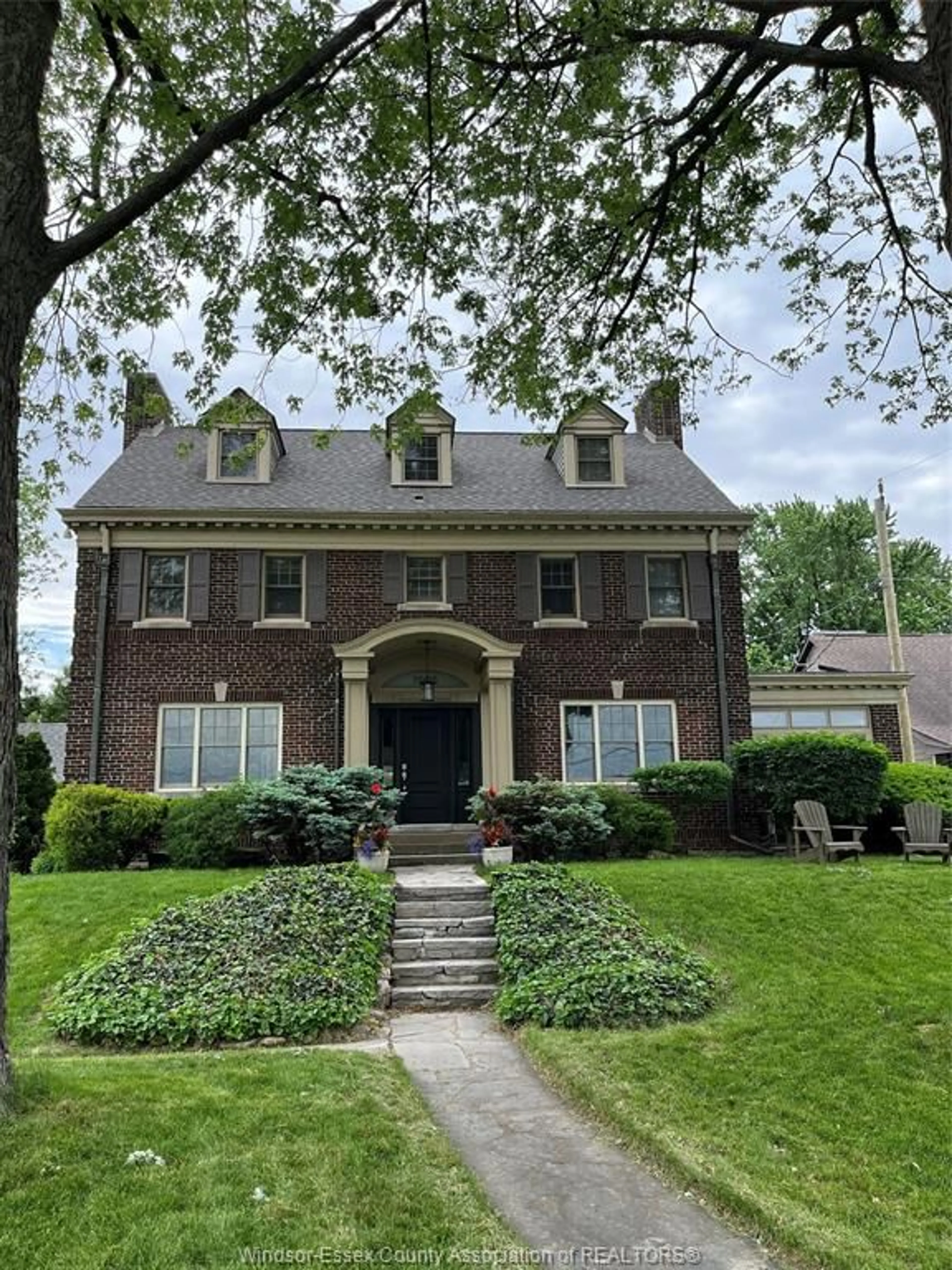 Home with brick exterior material, street for 7505 Riverside Dr, Windsor Ontario N8S 1C8