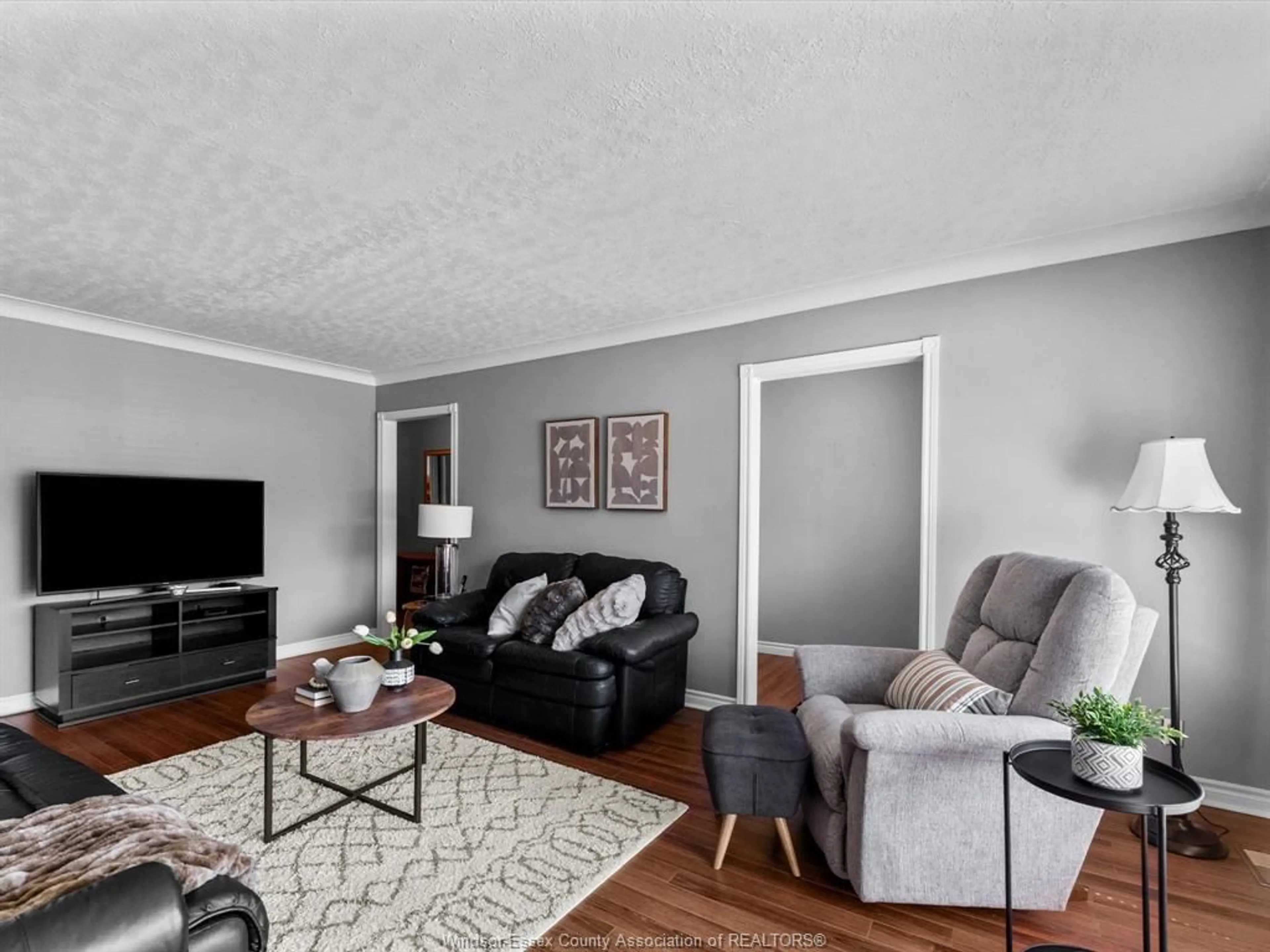 Living room with furniture, wood/laminate floor for 705 Optimist St, Belle River Ontario N8L 0J6