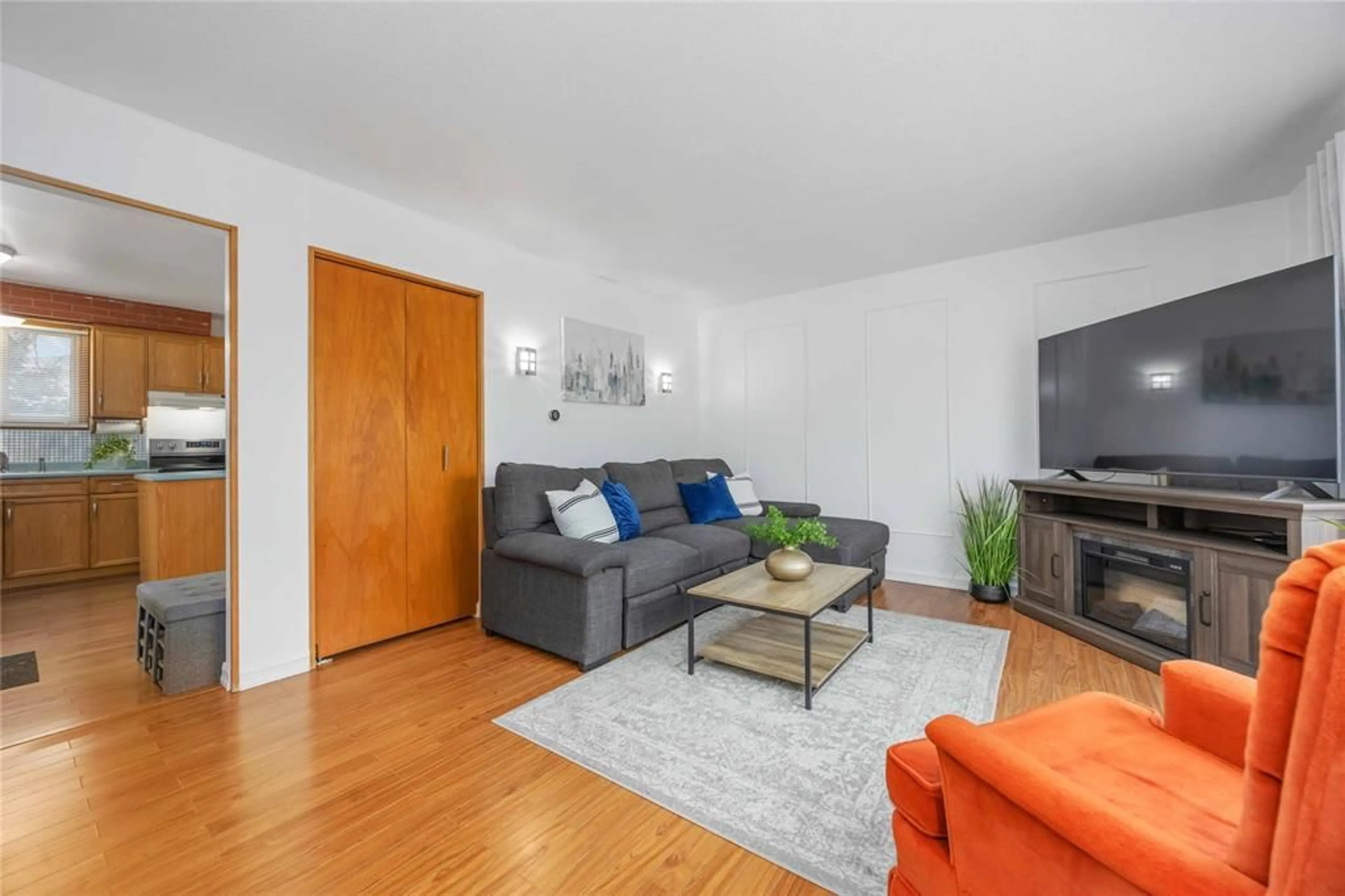 Living room with furniture, wood/laminate floor for 639 Stacy Crt, Sarnia Ontario N7S 4M5