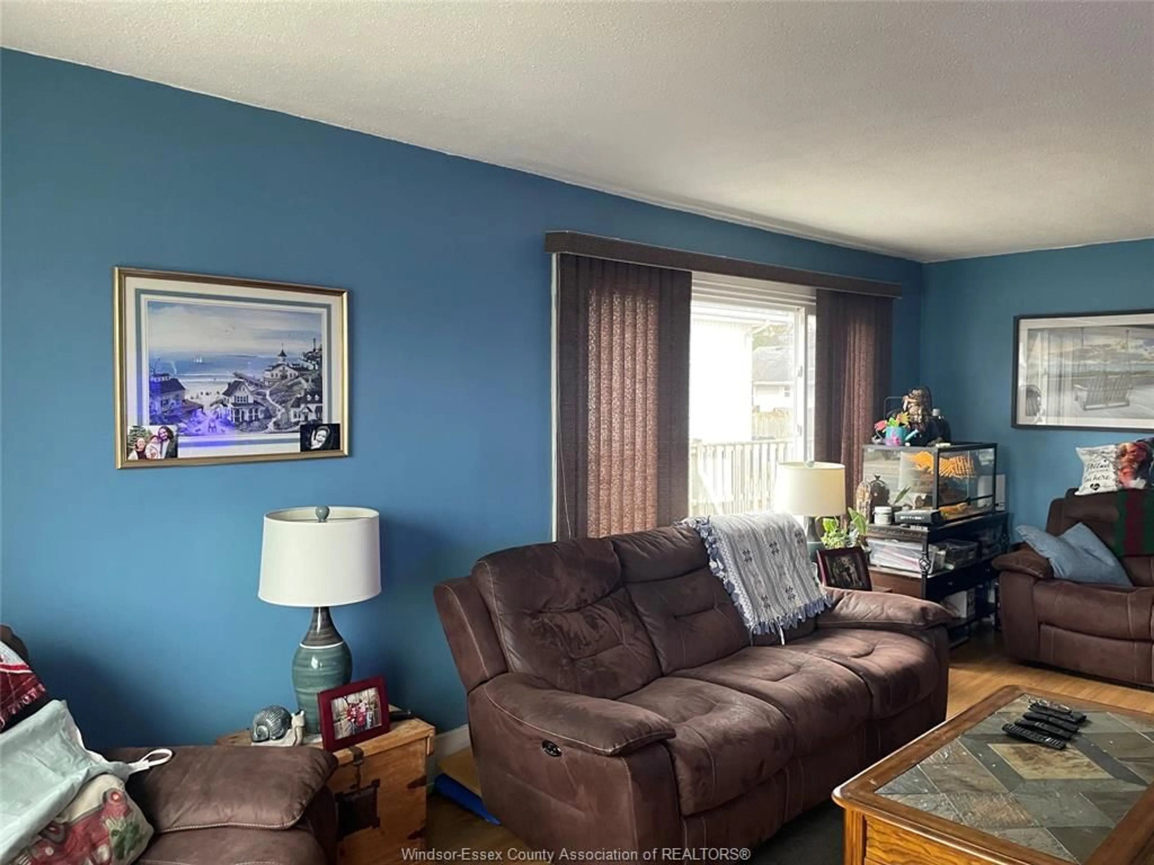 Living room with furniture, wood/laminate floor for 1673 Pillette Rd, Windsor Ontario N8Y 3C4