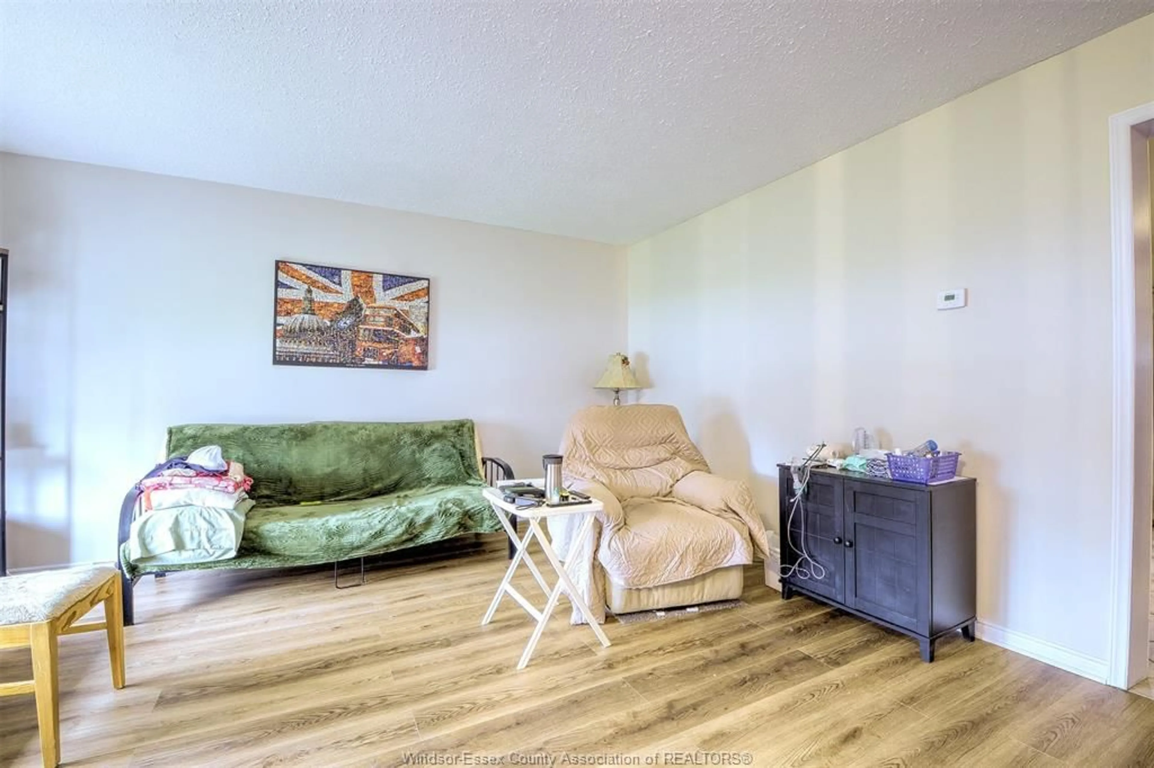 Living room with furniture, wood/laminate floor for 9445 ALTEN Dr, Windsor Ontario N8R 1V9