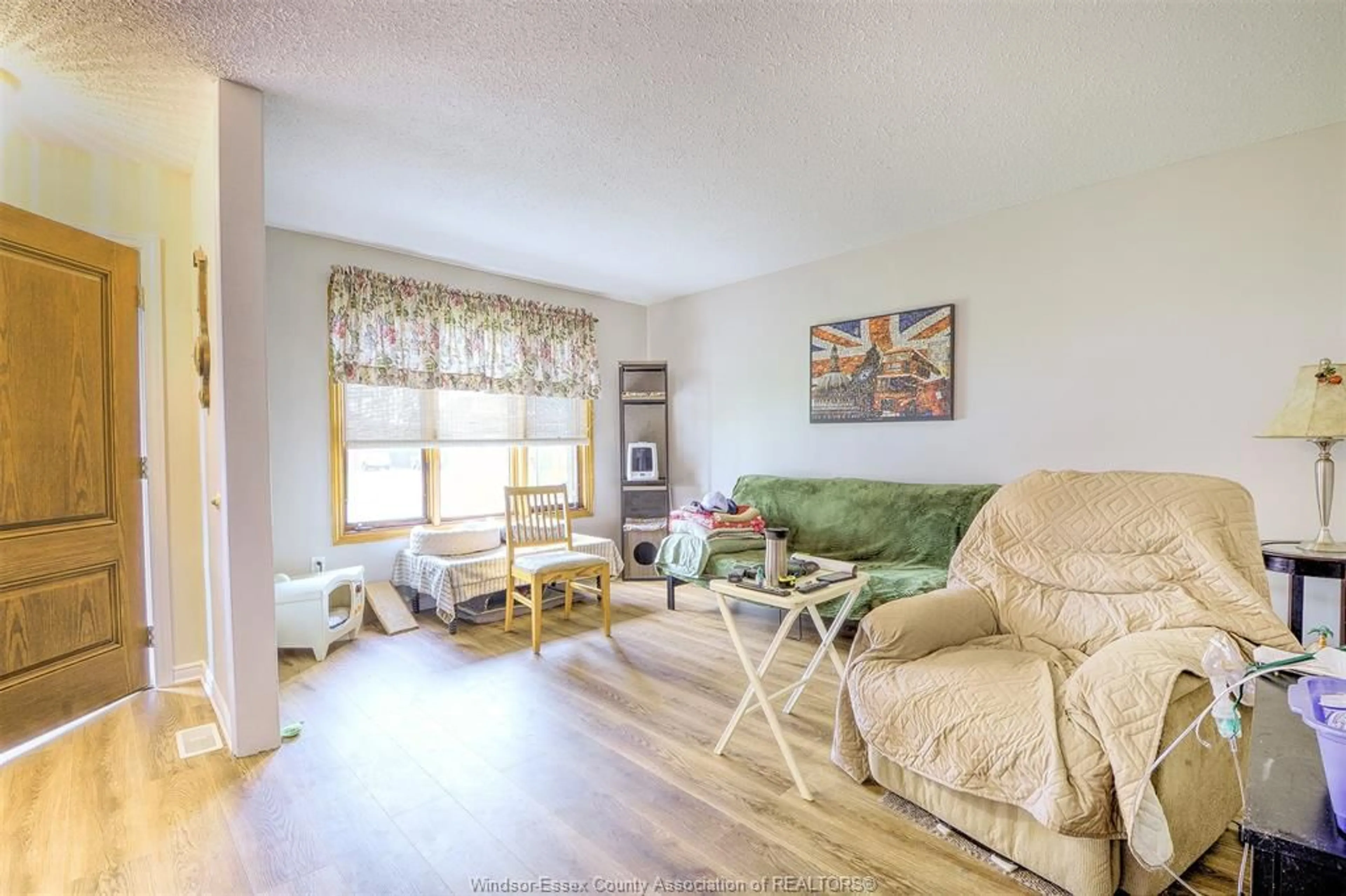 Living room with furniture, wood/laminate floor for 9445 ALTEN Dr, Windsor Ontario N8R 1V9